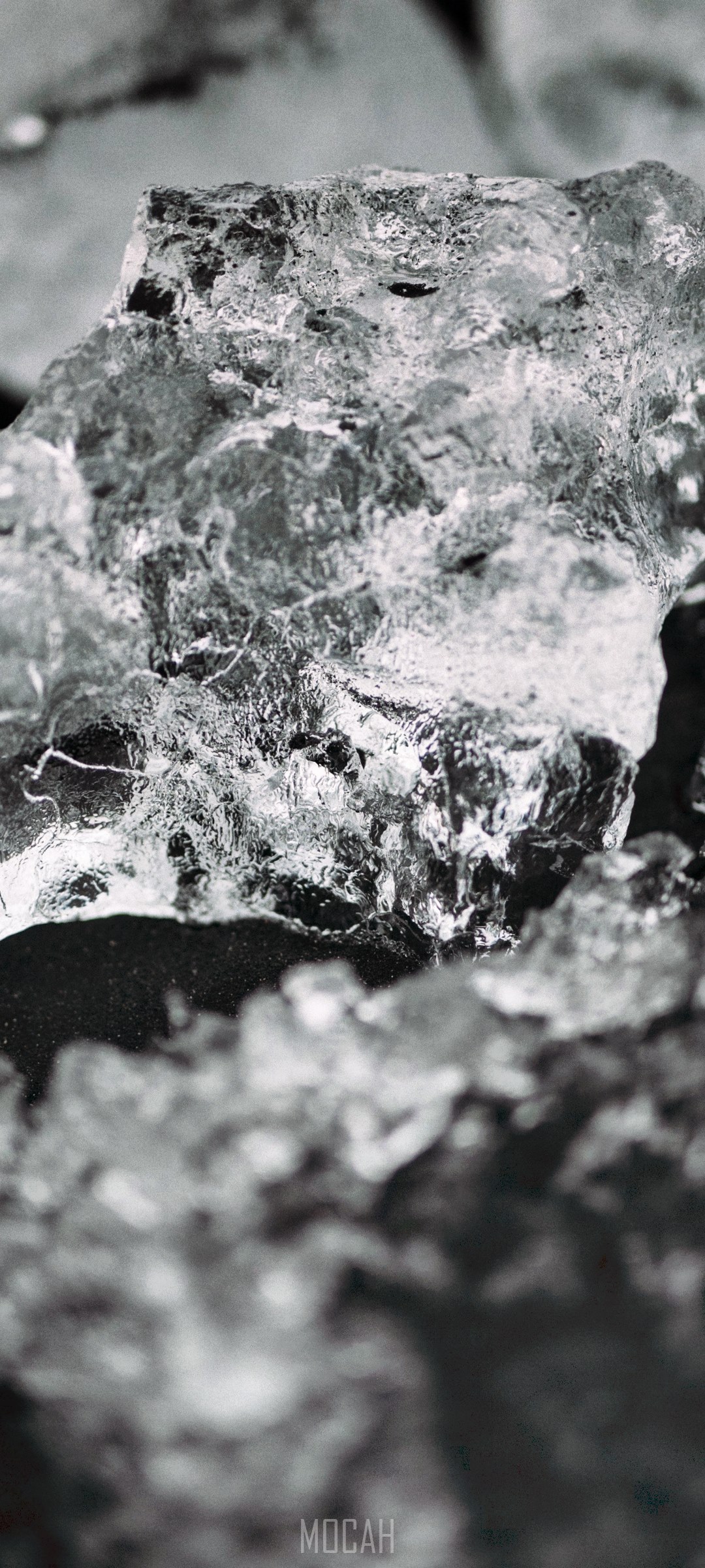 Close-up of ice crystals on dark soil HD Phone Wallpaper