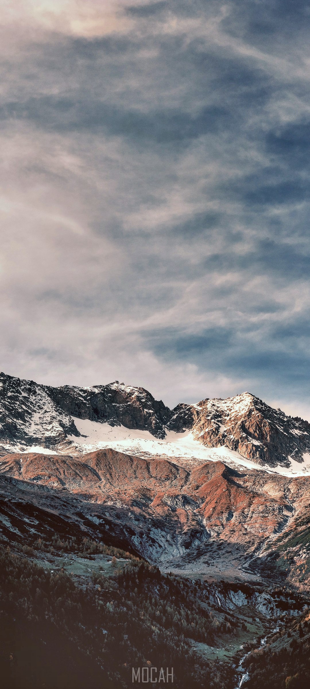 Snow-capped mountains under a cloudy sky HD Phone Wallpaper