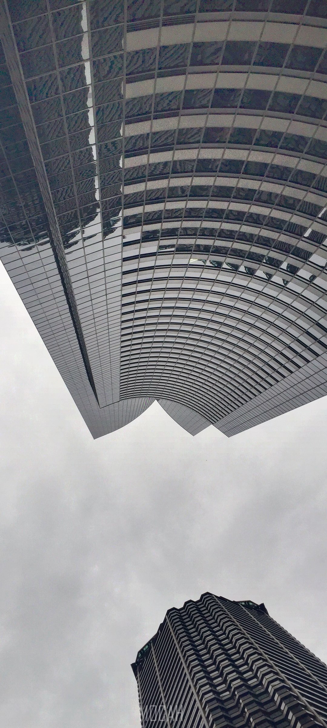Modern skyscrapers against a cloudy sky HD Phone Wallpaper