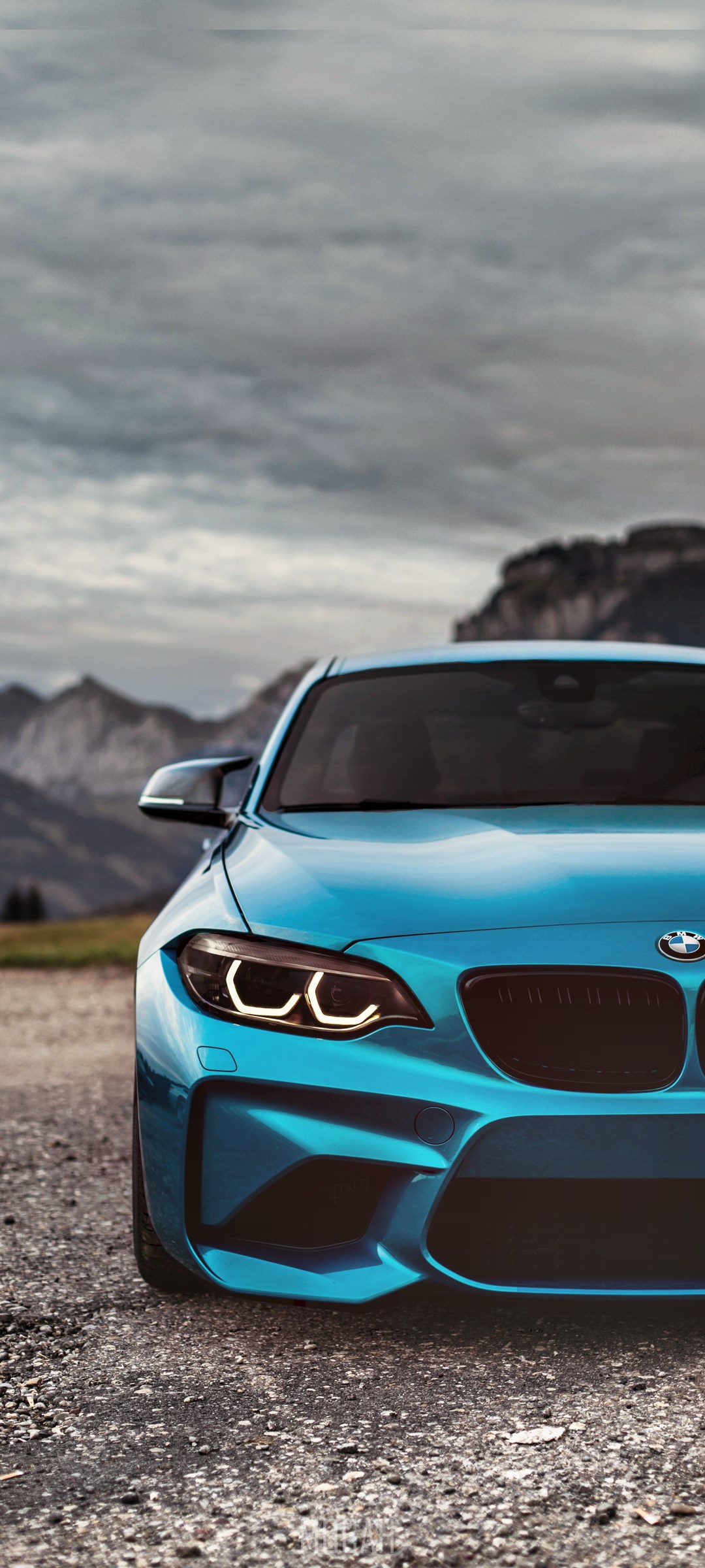 Blue BMW M2 Coupe on Gravel Road with Mountains HD Phone Wallpaper