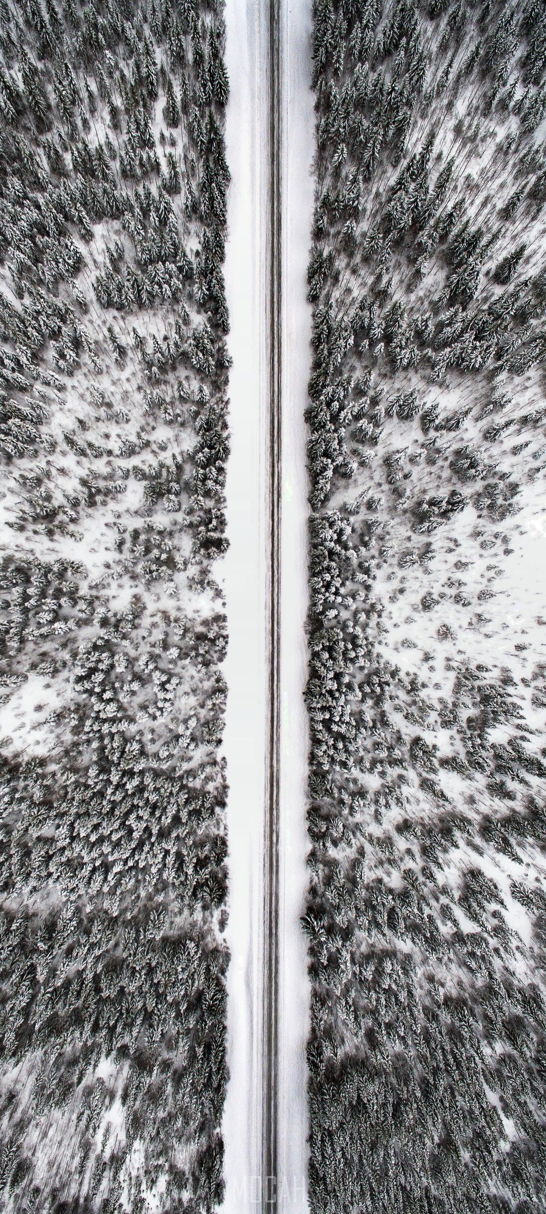 Aerial view of a road through a snowy forest in Jamtland County HD Phone Wallpaper