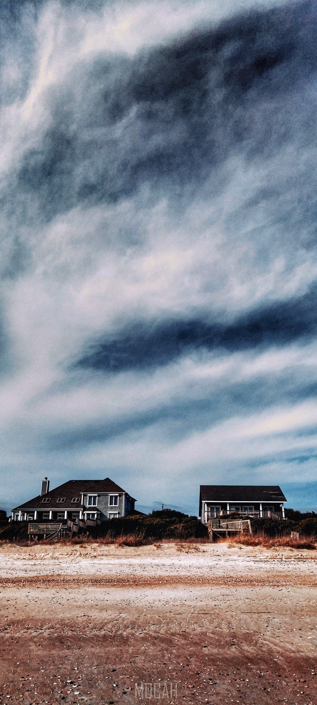 Beach houses under a cloudy sky HD Phone Wallpaper