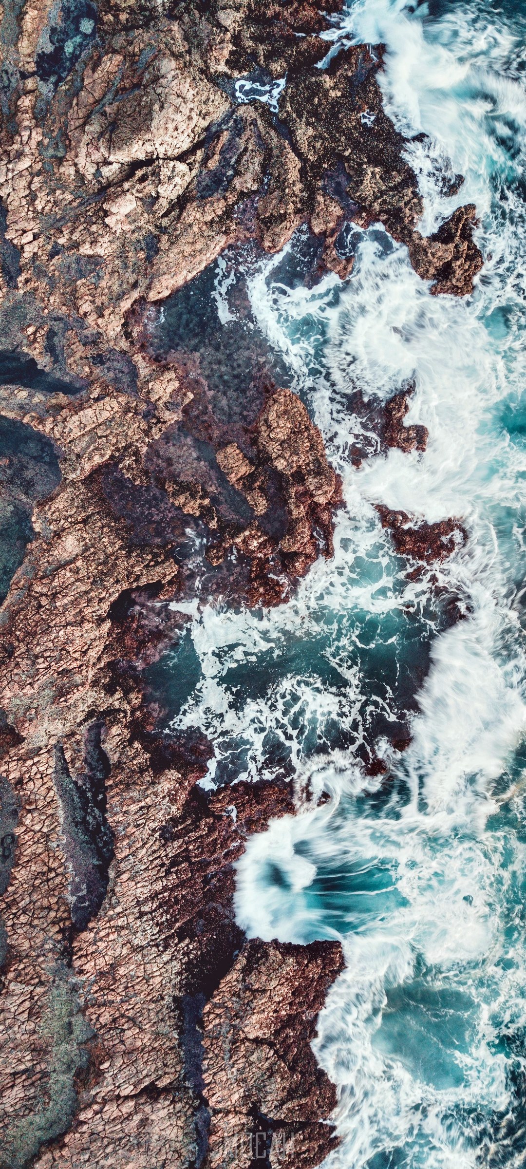 Aerial view of rocky coastline with crashing waves HD Phone Wallpaper