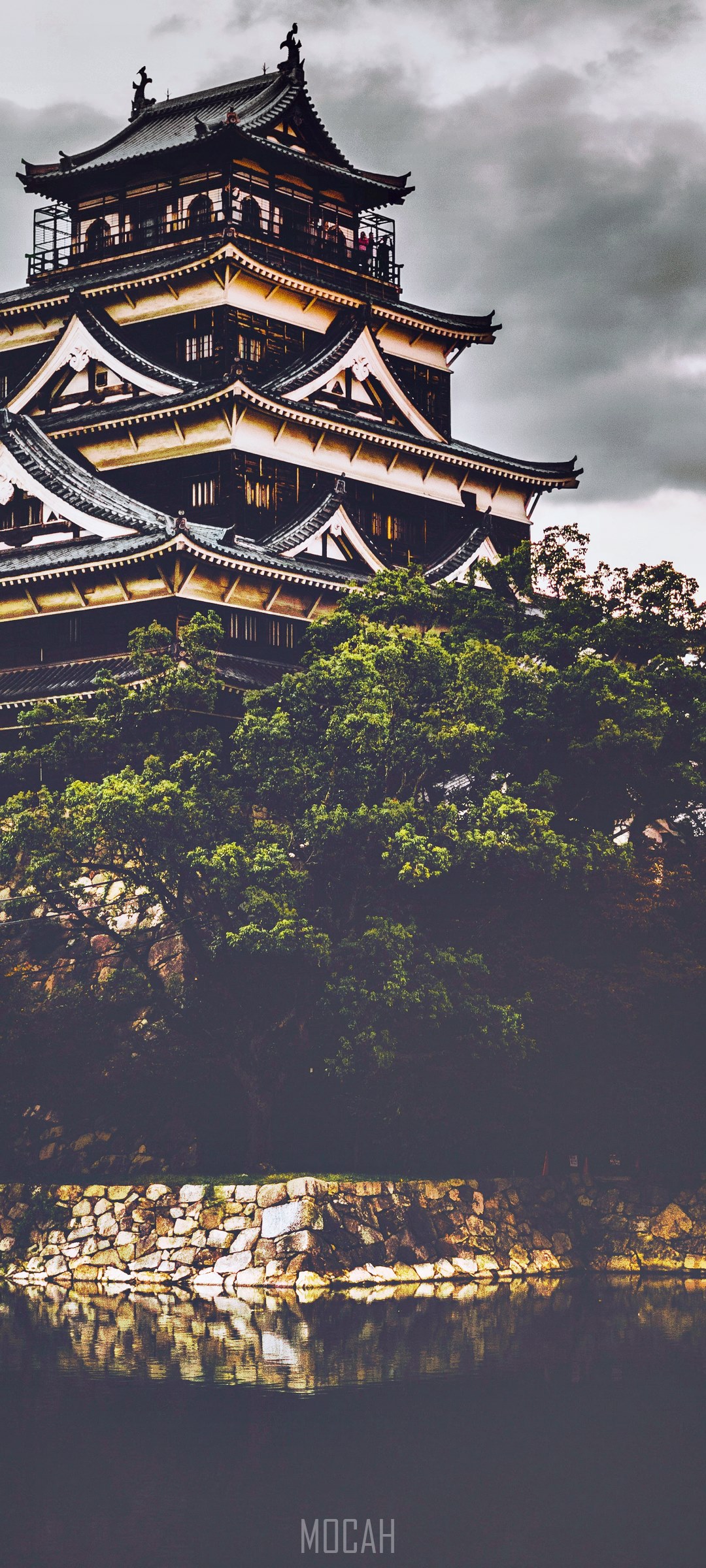 Japanese castle on a hill with trees and water HD Phone Wallpaper