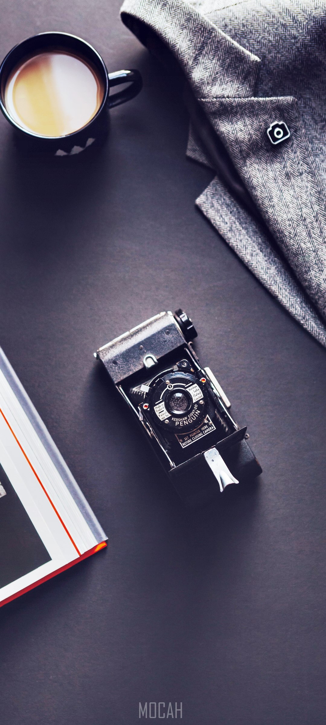 Flatlay of vintage camera, jacket, coffee, and book HD Phone Wallpaper