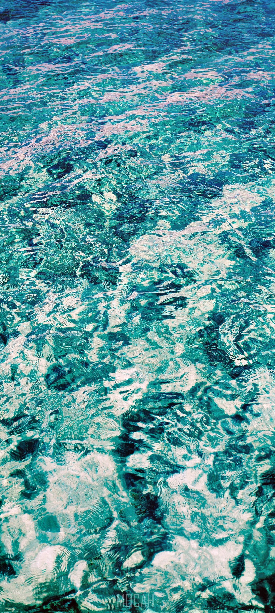 Turquoise water with ripples and light reflections HD Phone Wallpaper