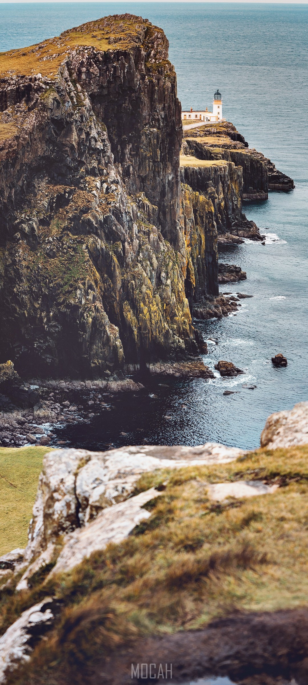Neist Point Lighthouse on a rocky cliff overlooking the sea HD Phone Wallpaper