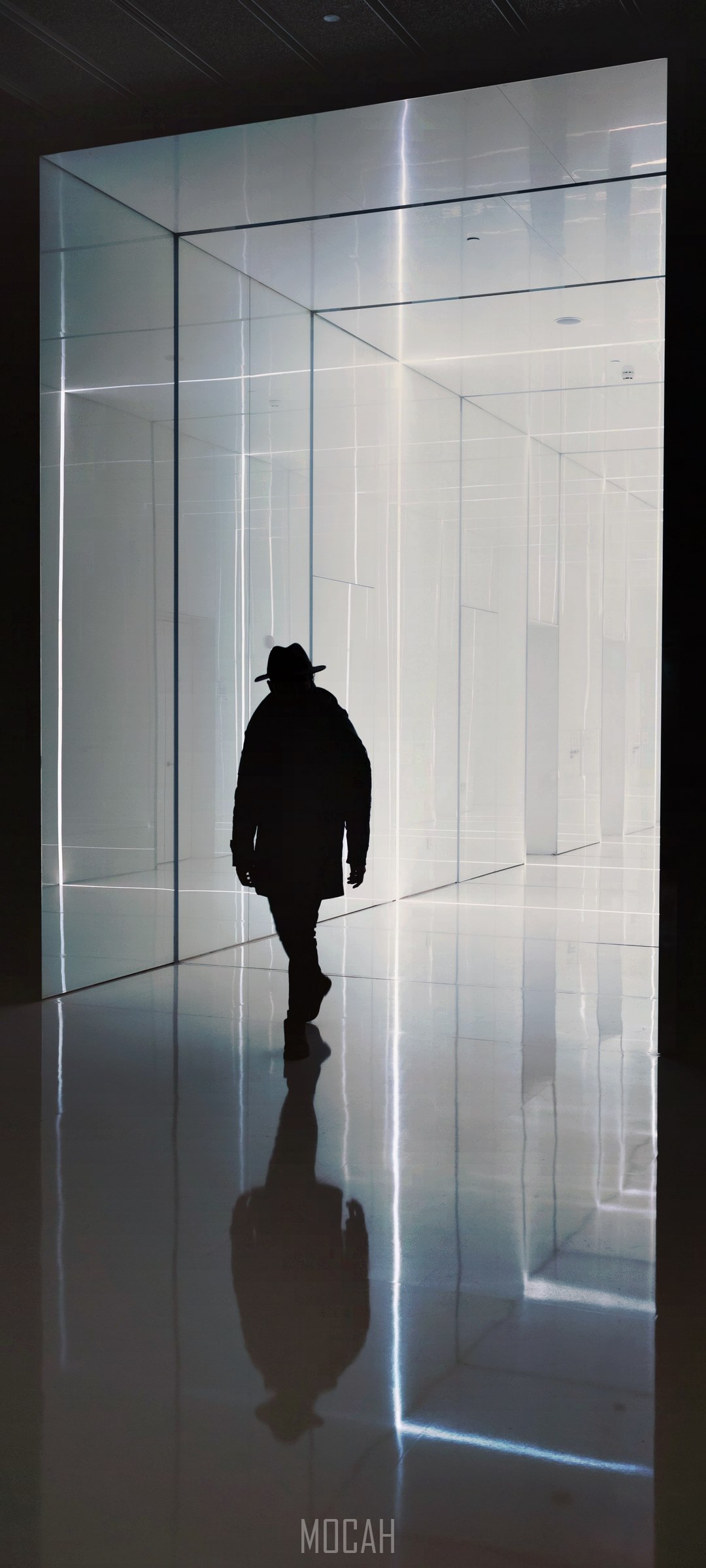 Silhouette of a person in a hat walking in a modern hallway HD Phone Wallpaper