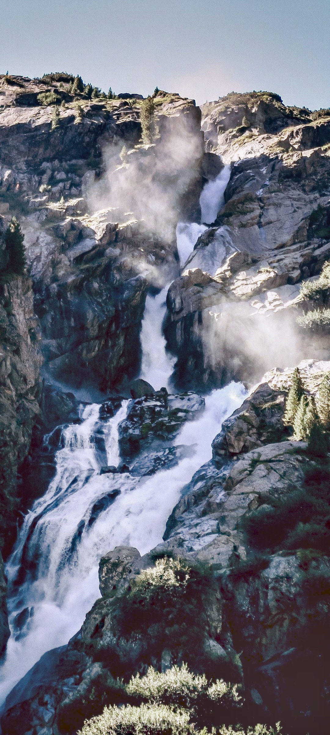Waterfall cascading down rocky mountain HD Phone Wallpaper