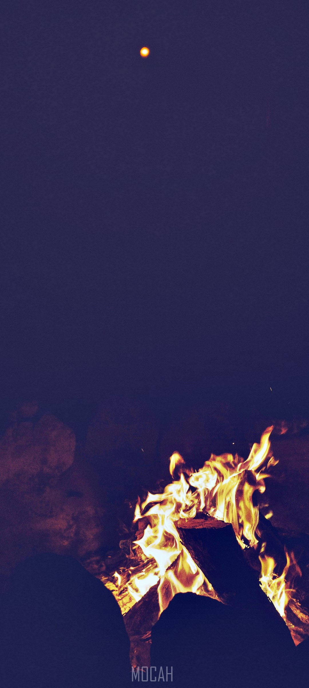 Campfire at night with a distant light HD Phone Wallpaper