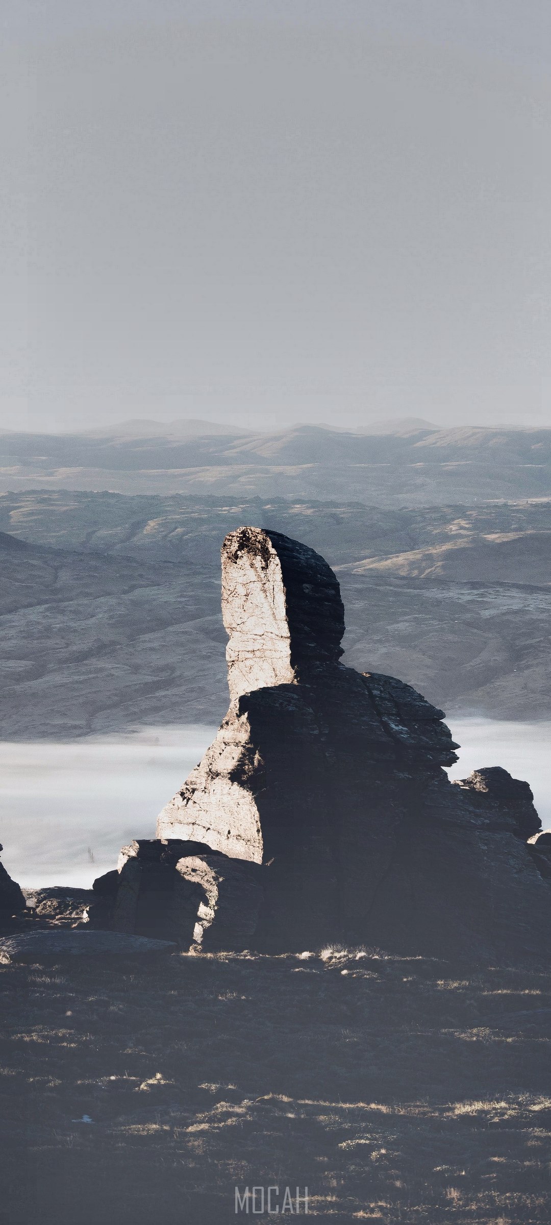 Lone rock pillar in a misty mountain landscape HD Phone Wallpaper