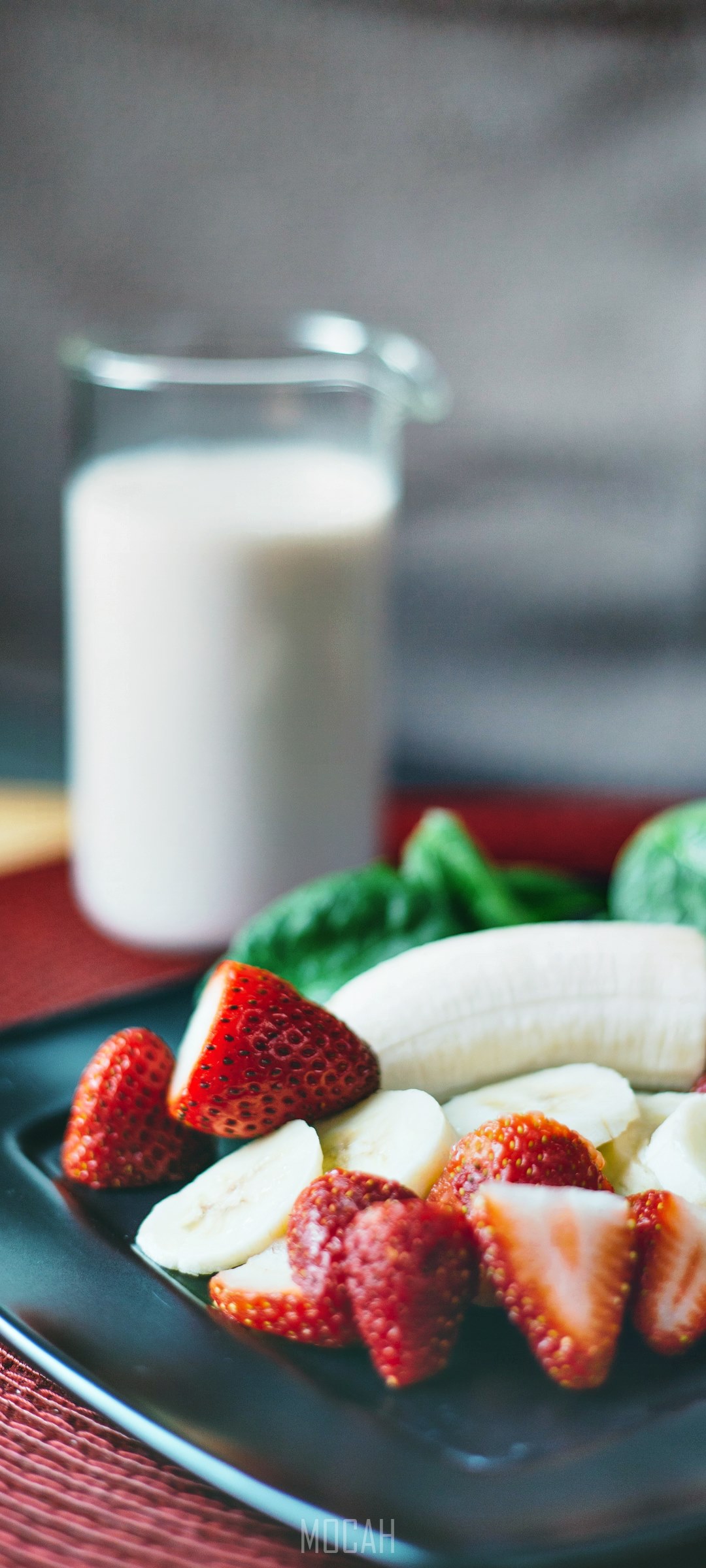 Strawberries, banana slices, and spinach with a jug of milk HD Phone Wallpaper