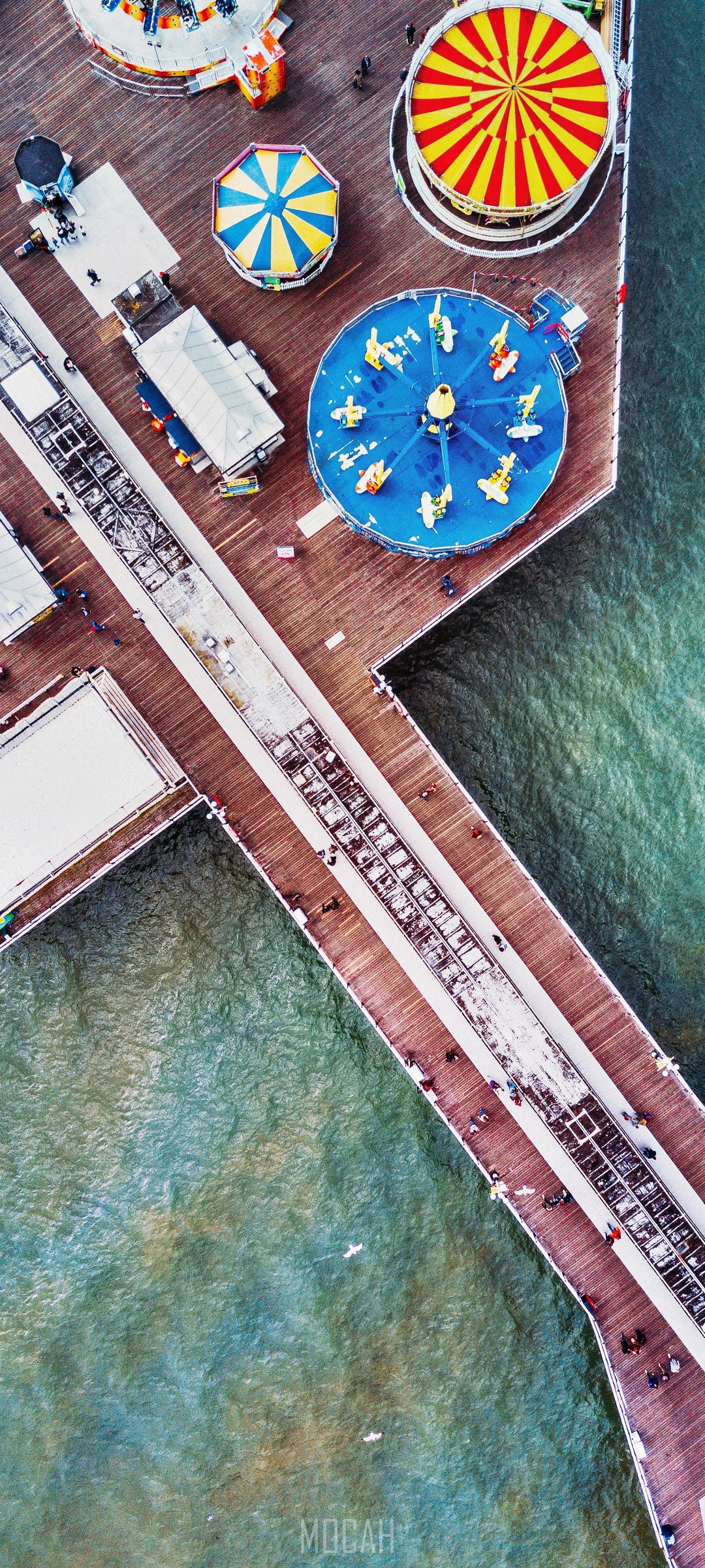 Aerial view of a pier with amusement park rides HD Phone Wallpaper
