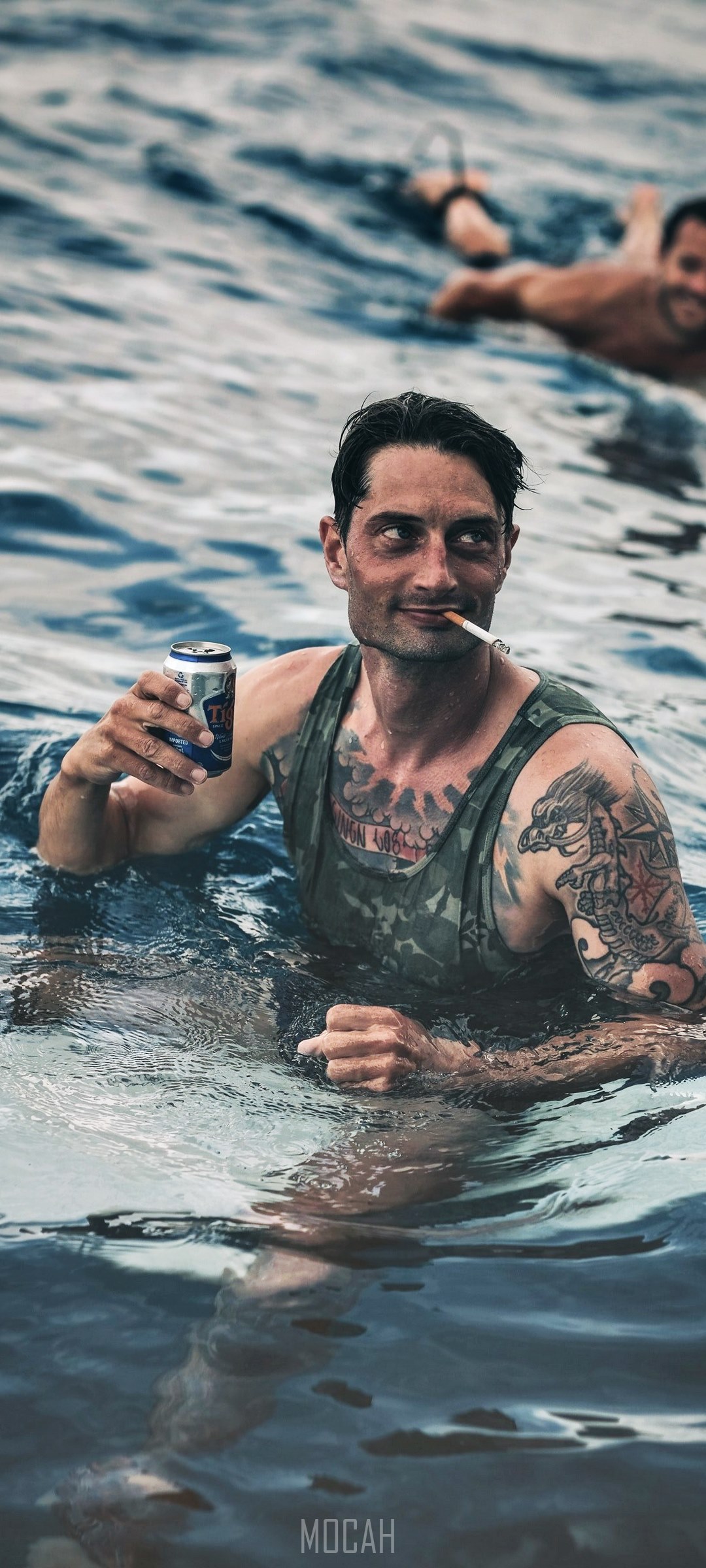 Man with tattoo and beer in ocean HD Phone Wallpaper