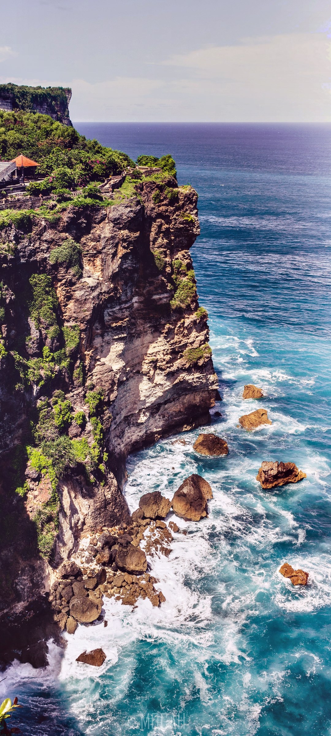 Cliff overlooking the ocean with a small building HD Phone Wallpaper