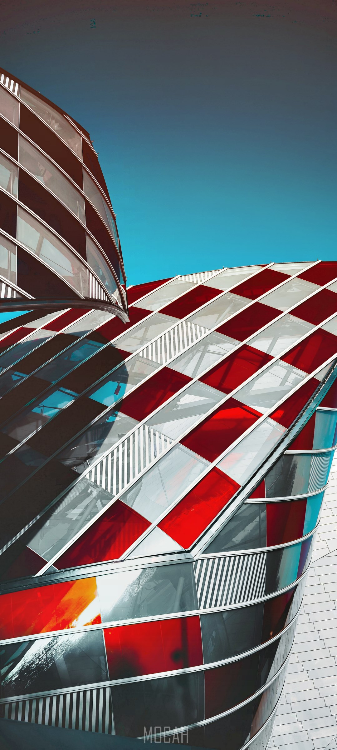 Modern curvy architectural building with red and clear glass panes HD Phone Wallpaper