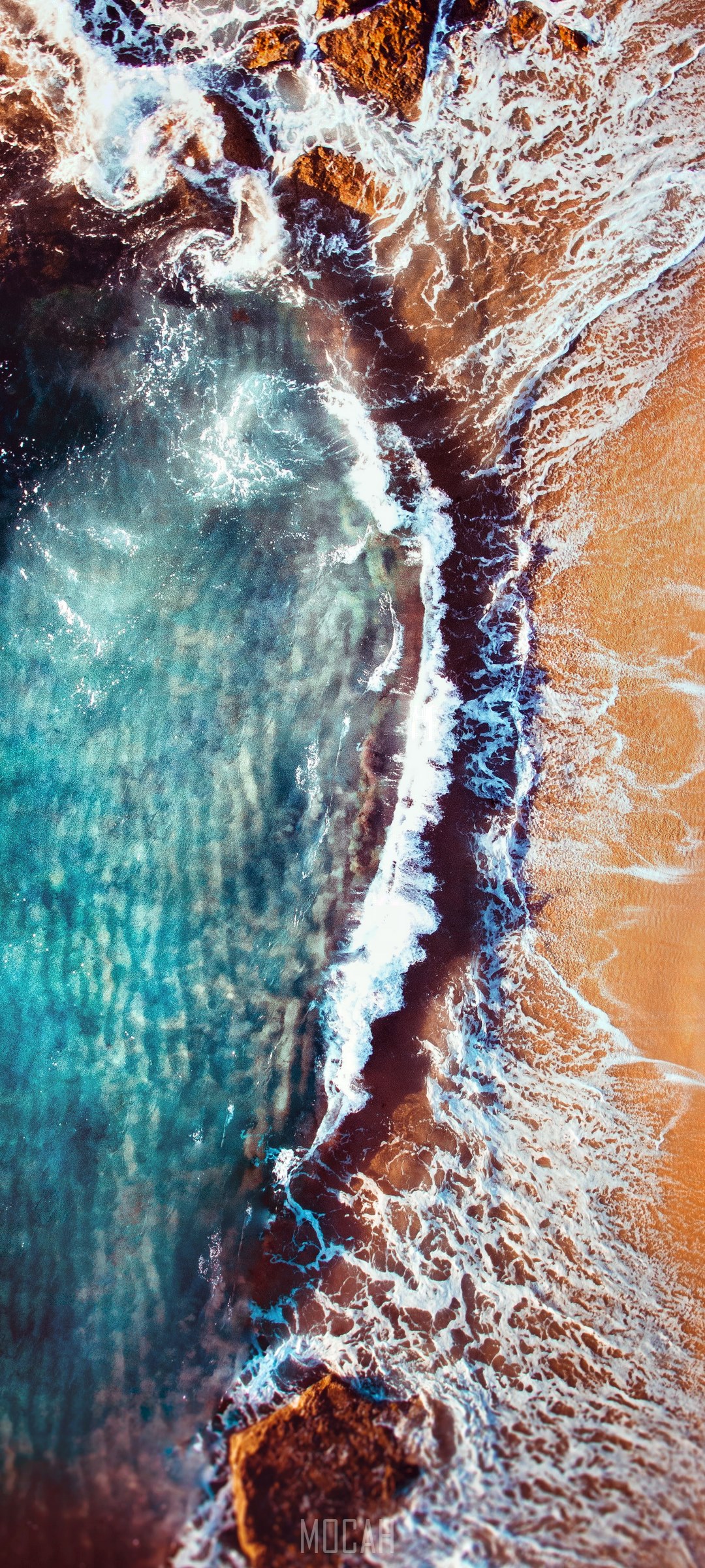 Aerial view of waves crashing on a rocky beach HD Phone Wallpaper