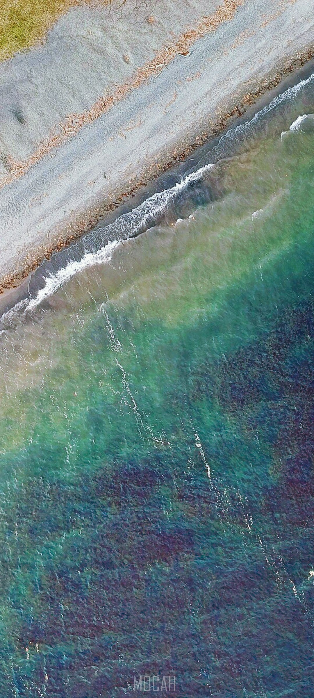 Aerial view of a rocky shore and turquoise ocean HD Phone Wallpaper