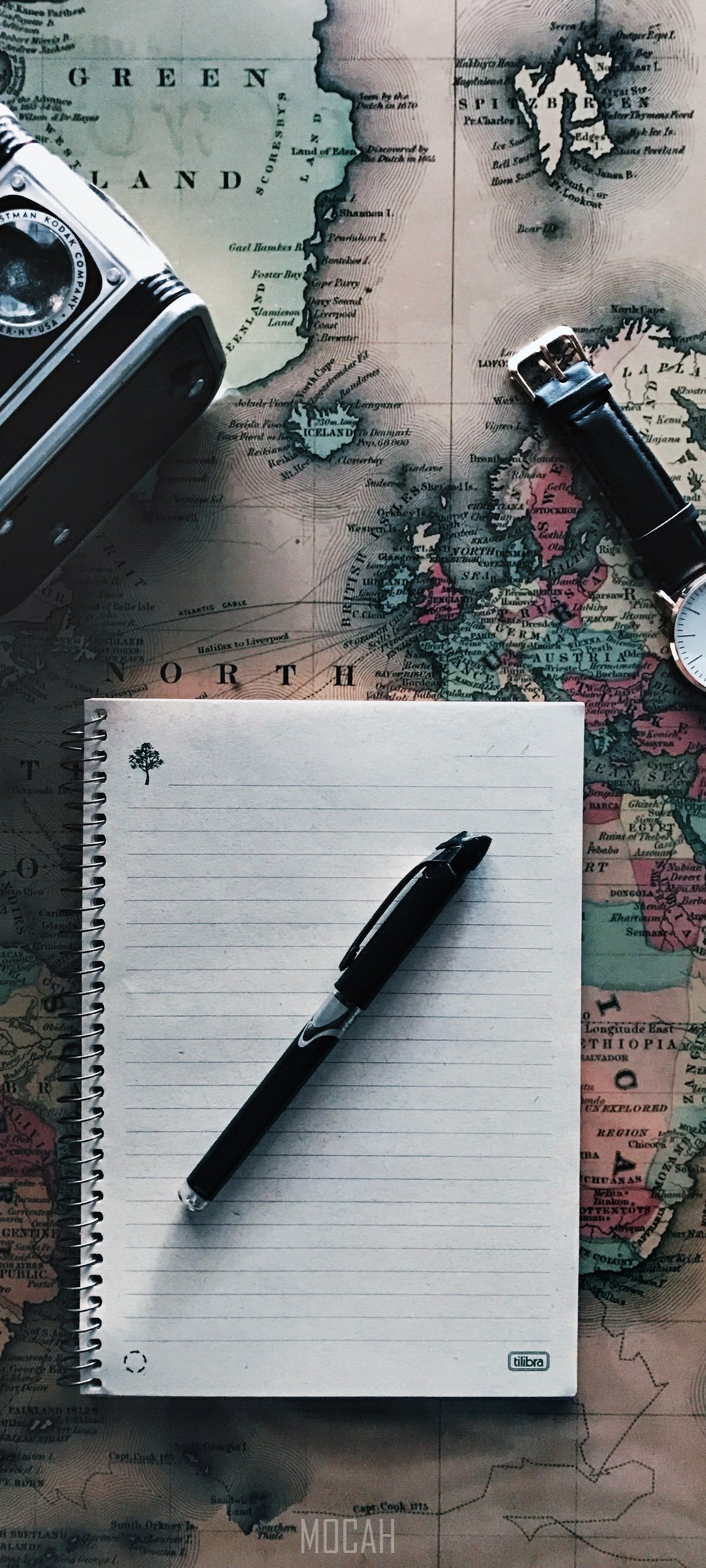 Travel flat lay with vintage map, camera, notebook, and pen HD Phone Wallpaper