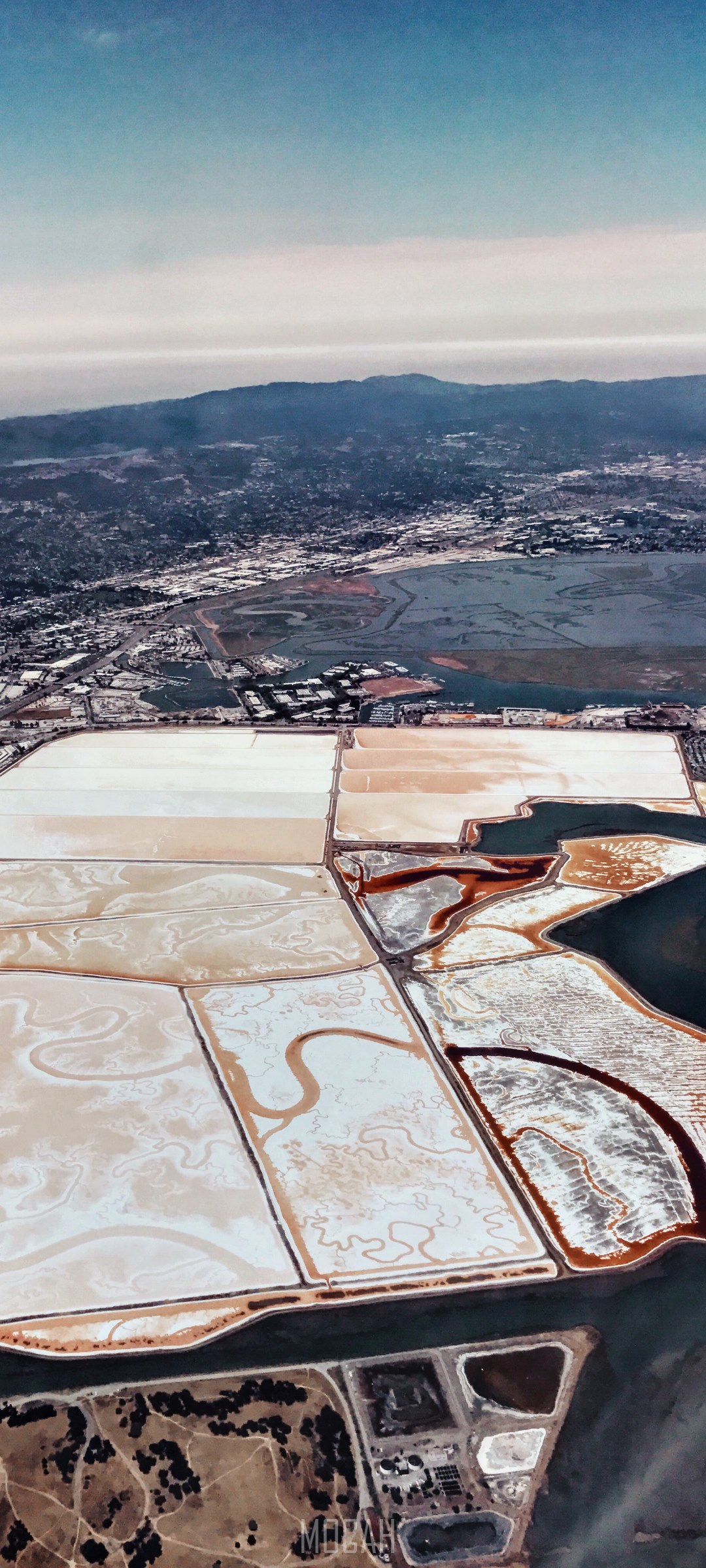 Aerial view of salt ponds and mountains HD Phone Wallpaper