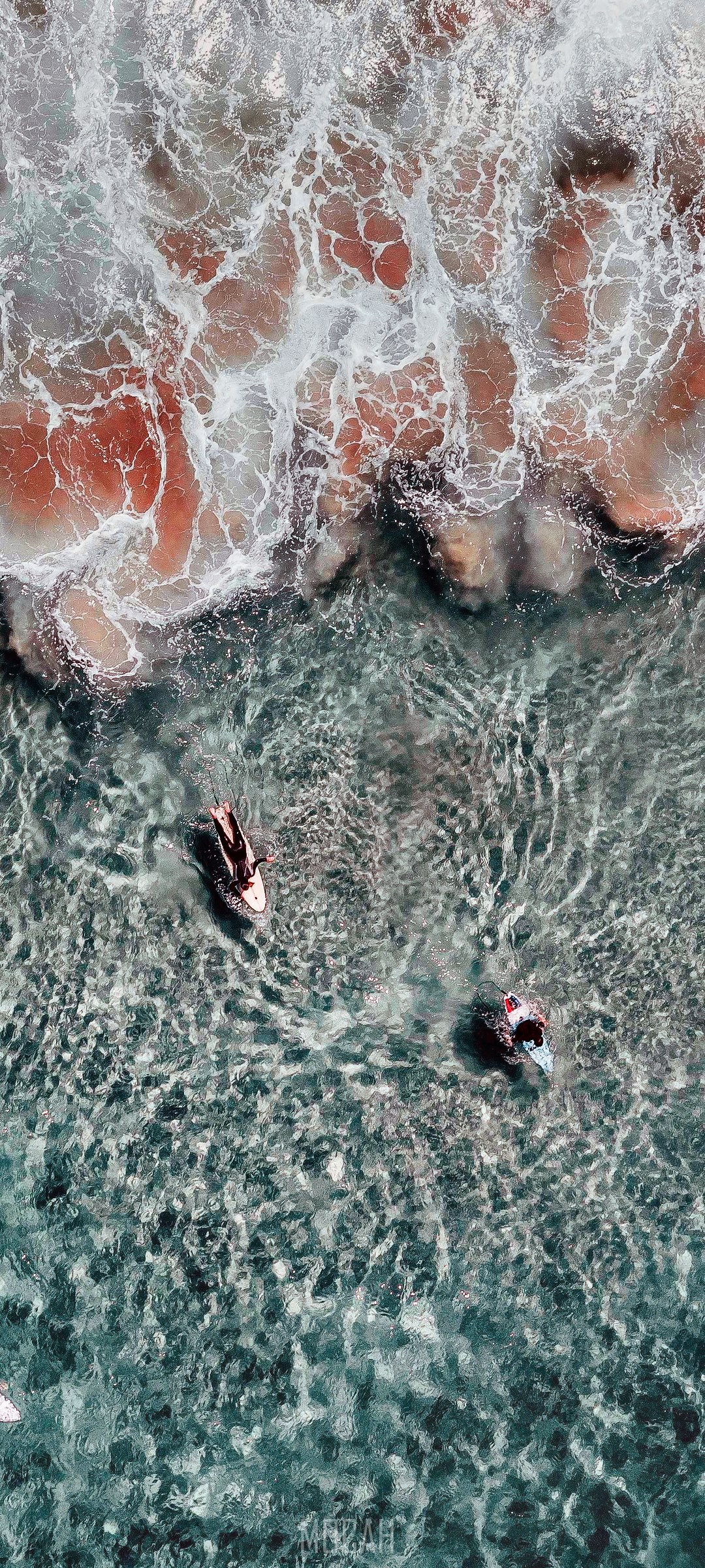Two surfers on surfboards in the ocean HD Phone Wallpaper