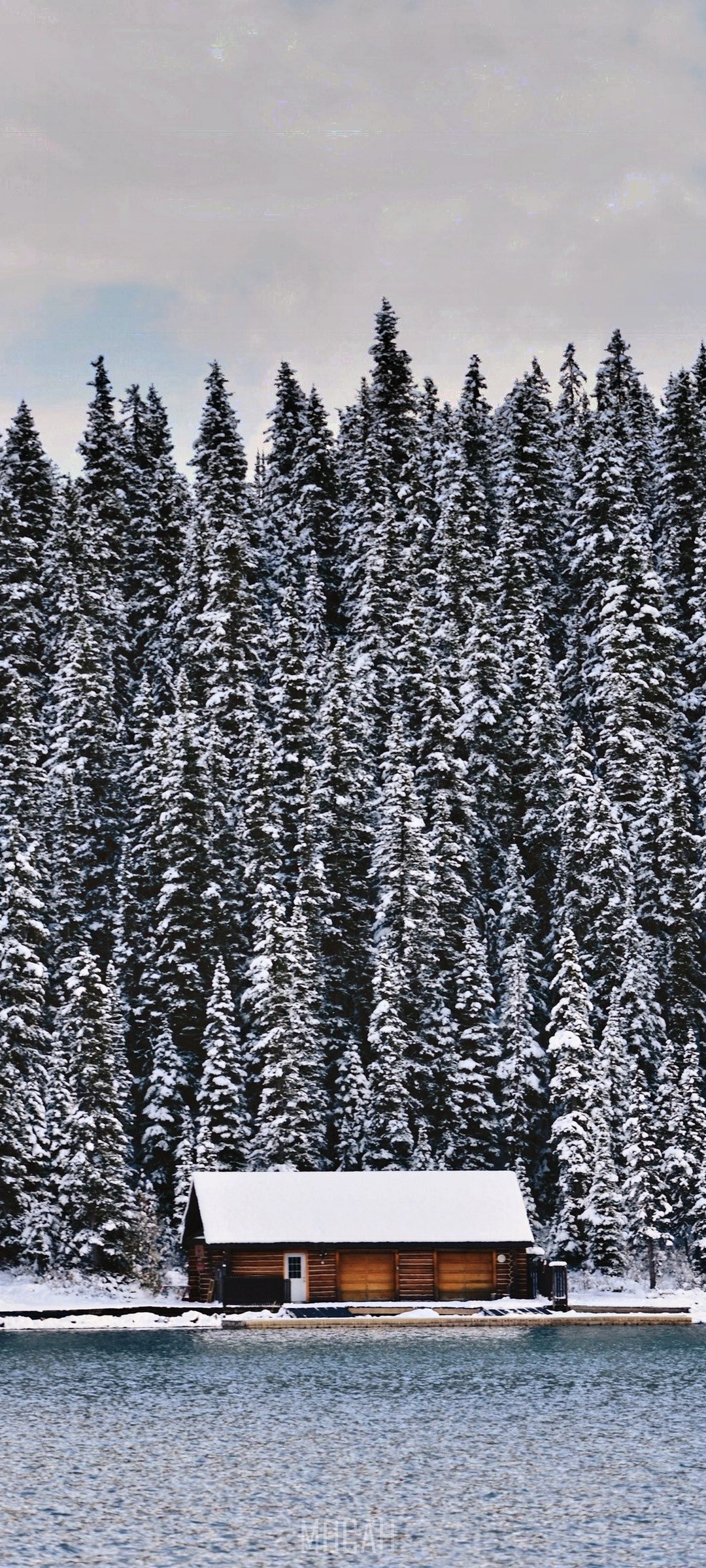Snow-covered cabin by a lake and forest HD Phone Wallpaper