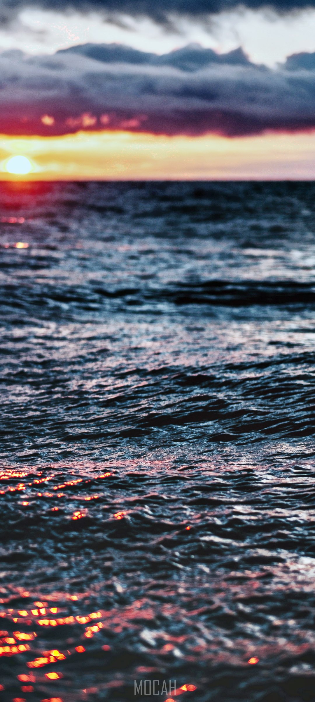 Sunset over the ocean with dramatic clouds HD Phone Wallpaper