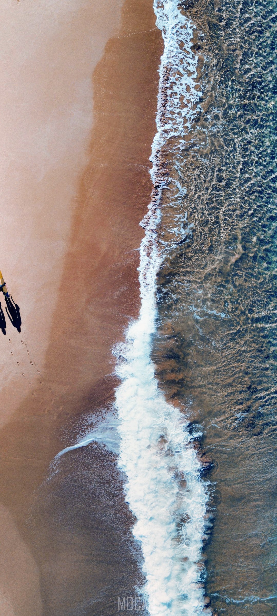 Aerial view of a beach with waves and two people HD Phone Wallpaper