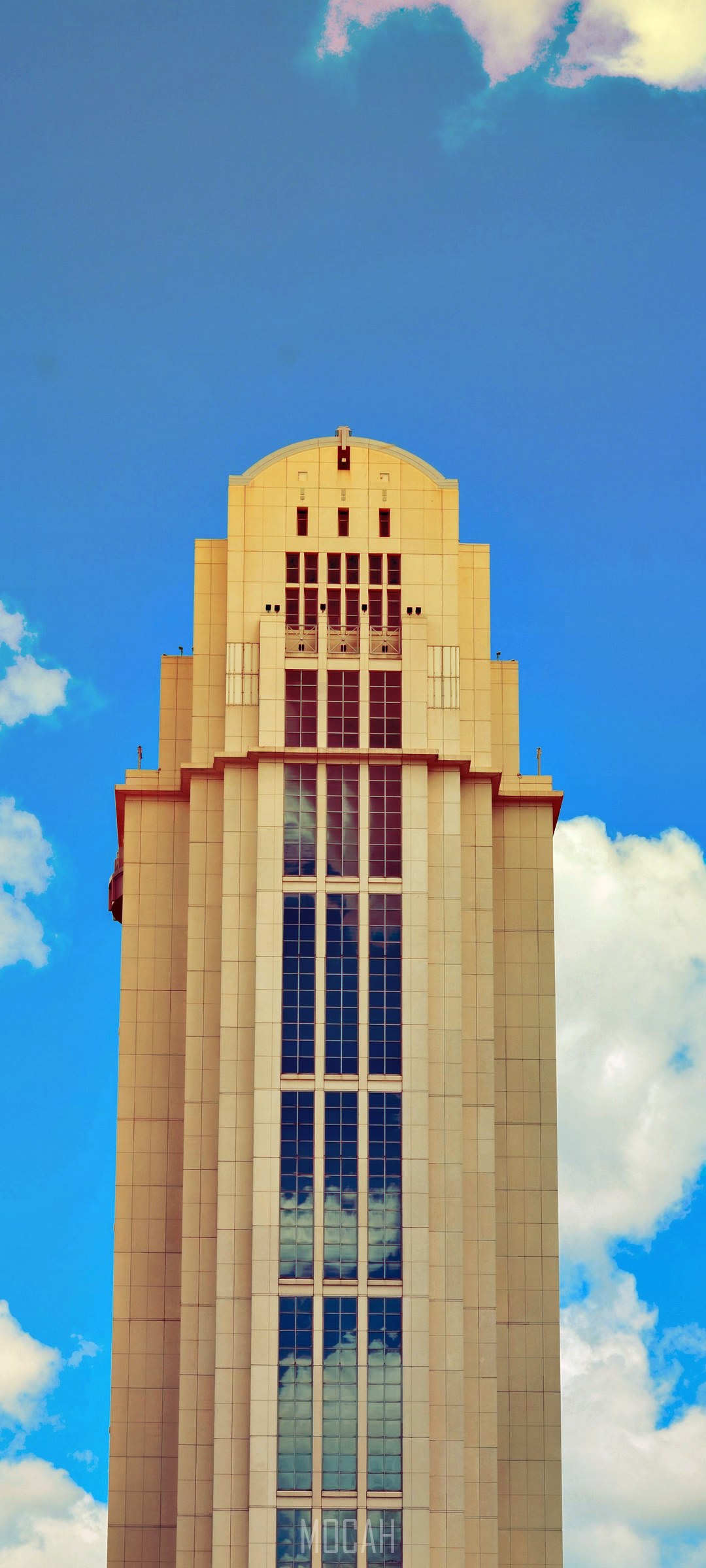 Art Deco skyscraper against a blue sky with clouds HD Phone Wallpaper