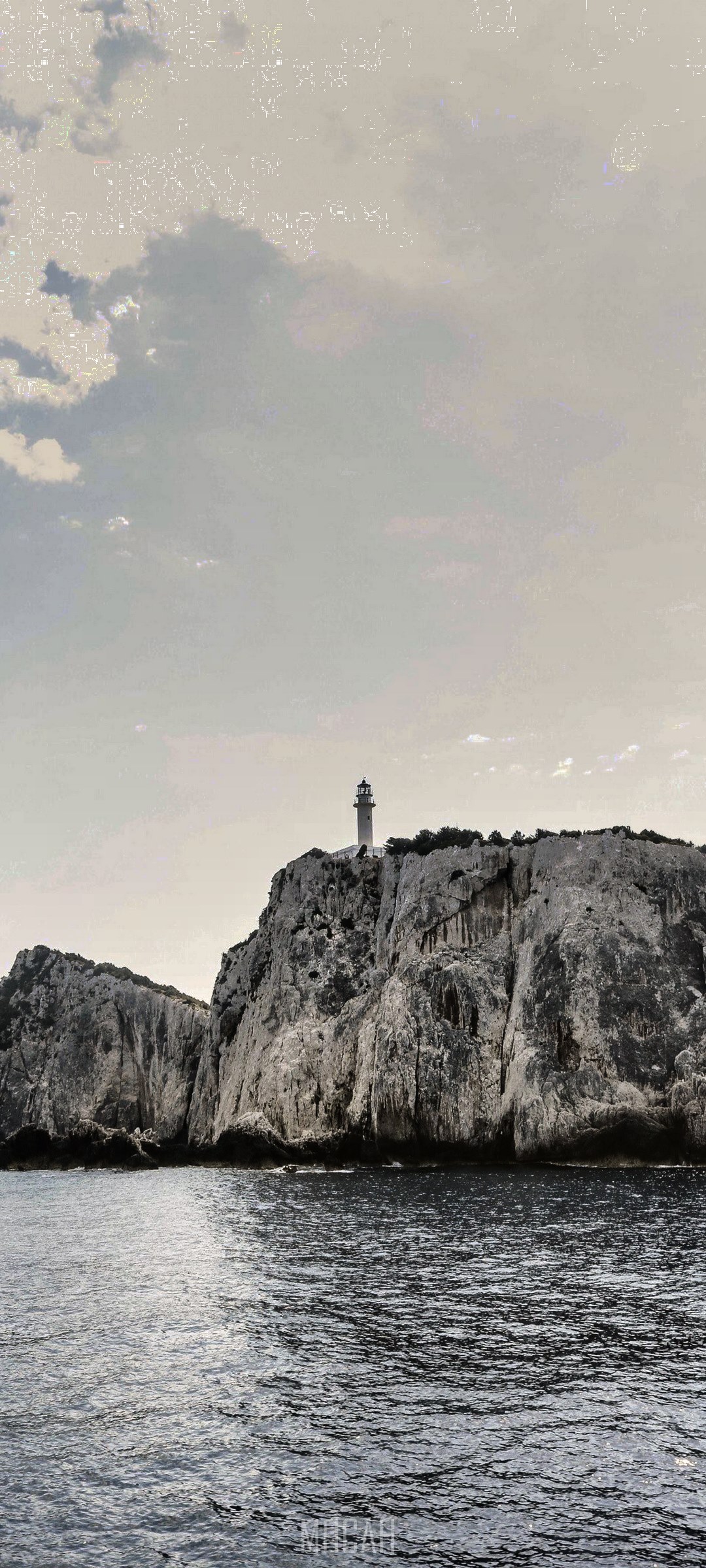 Lighthouse on a rocky cliff overlooking the sea HD Phone Wallpaper