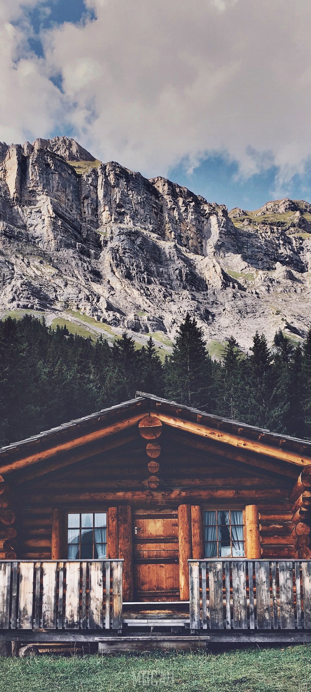 Log cabin in front of a rocky mountain and forest HD Phone Wallpaper