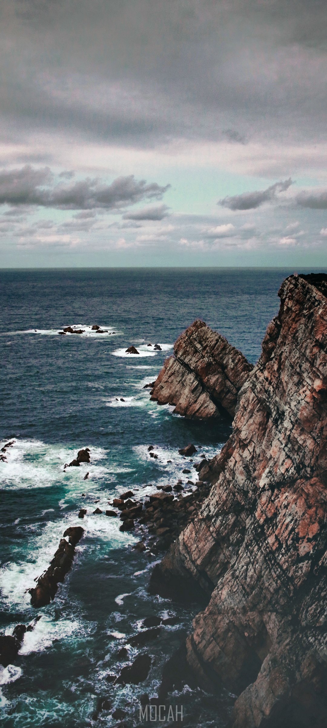 Rocky Coastline with Crashing Waves and Cloudy Sky HD Phone Wallpaper