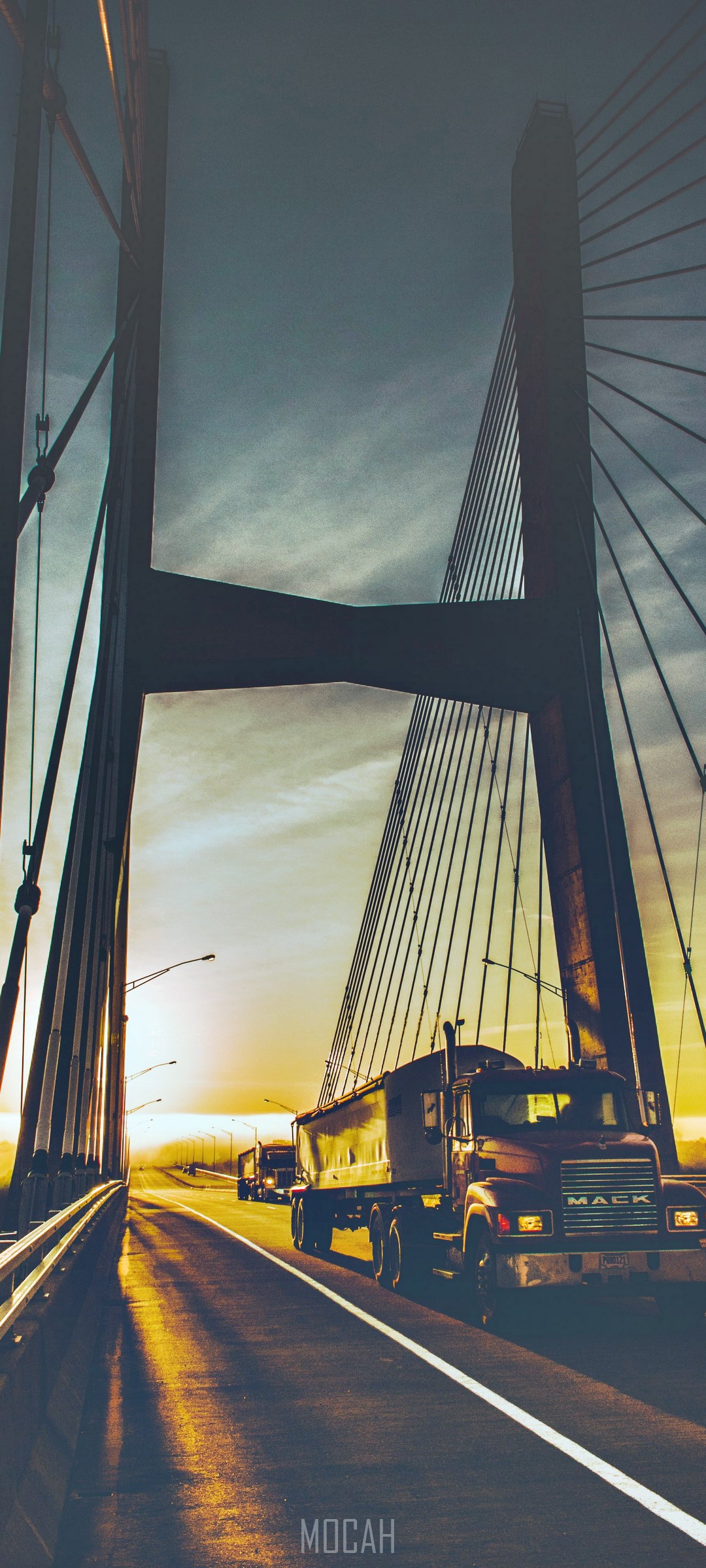 Mack trucks on a bridge at sunrise HD Phone Wallpaper