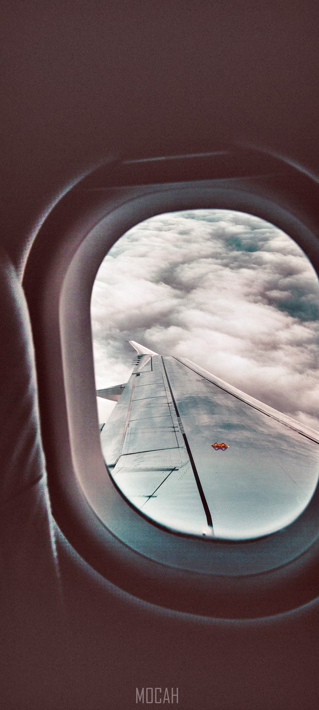 Airplane wing over clouds seen through window HD Phone Wallpaper