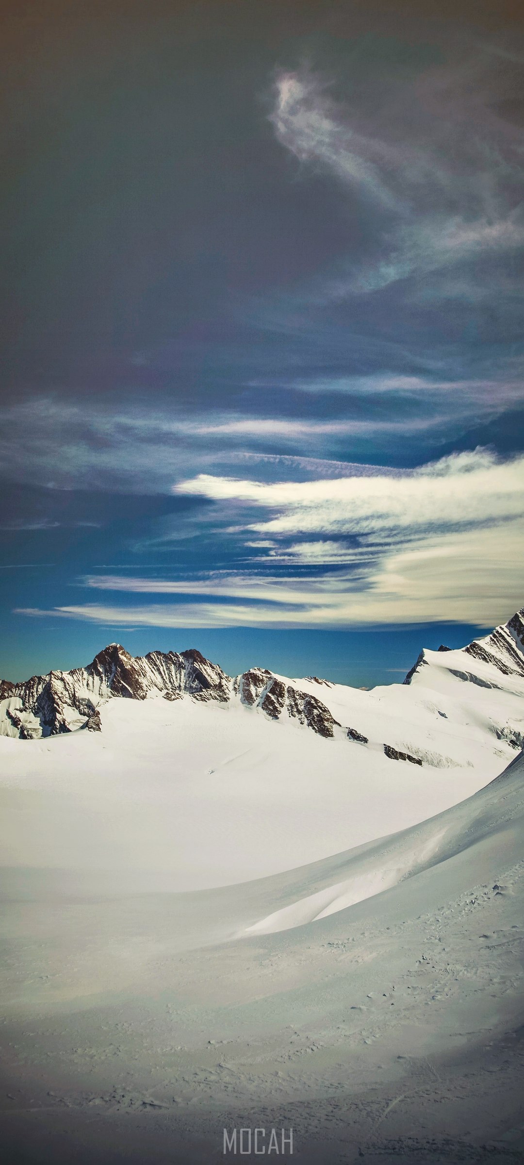 Snowcapped mountains in Ewigschneefeld under a cloudy sky HD Phone Wallpaper
