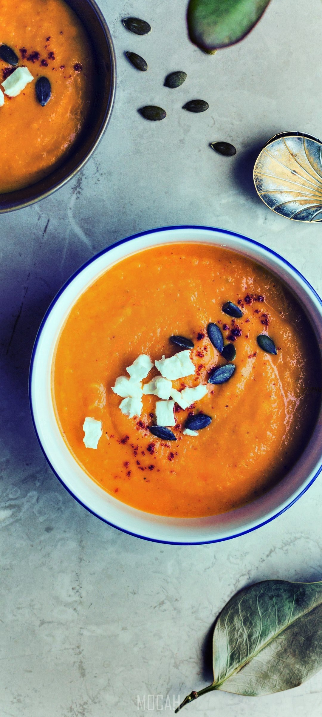 Bowls of orange squash soup with feta and pumpkin seeds HD Phone Wallpaper