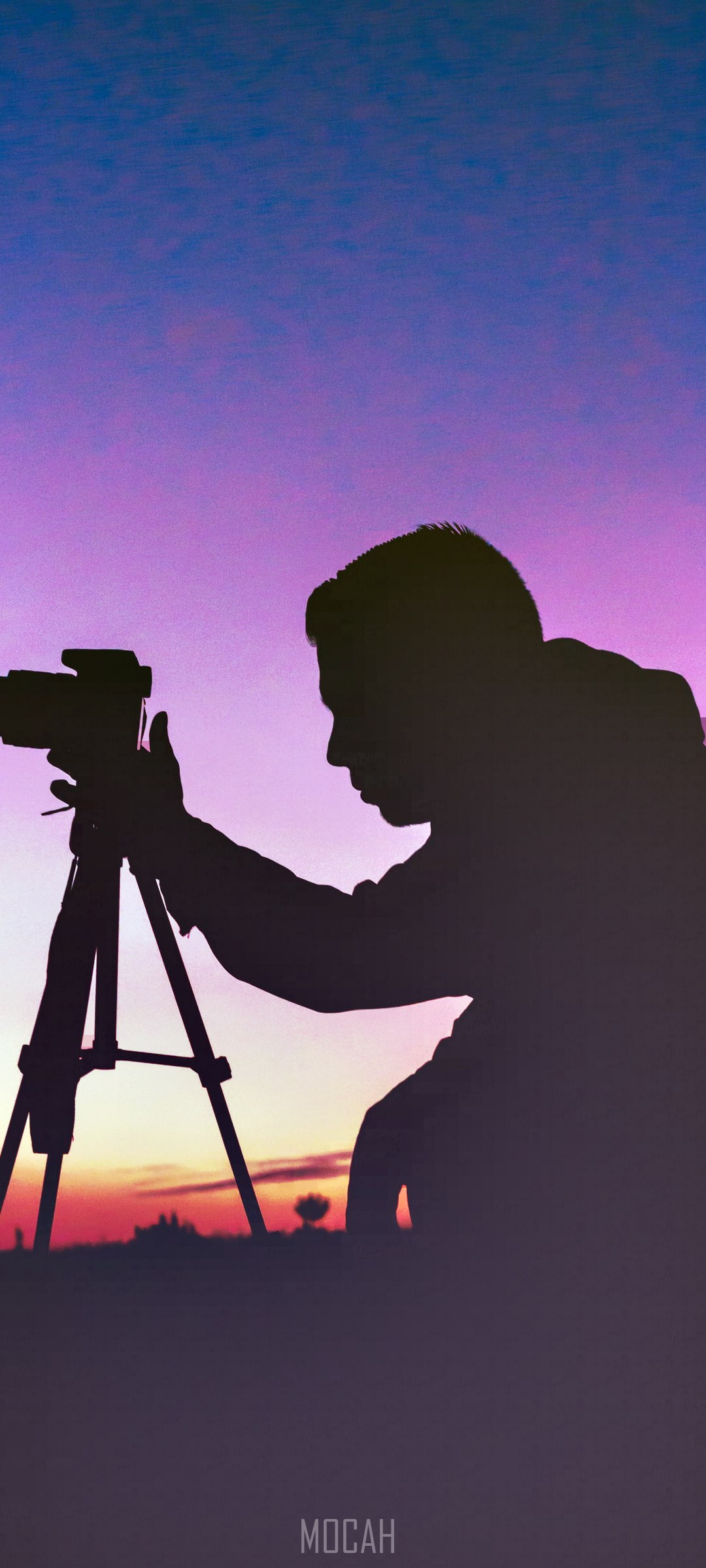 Silhouette of a photographer with a camera on a tripod at sunset HD Phone Wallpaper