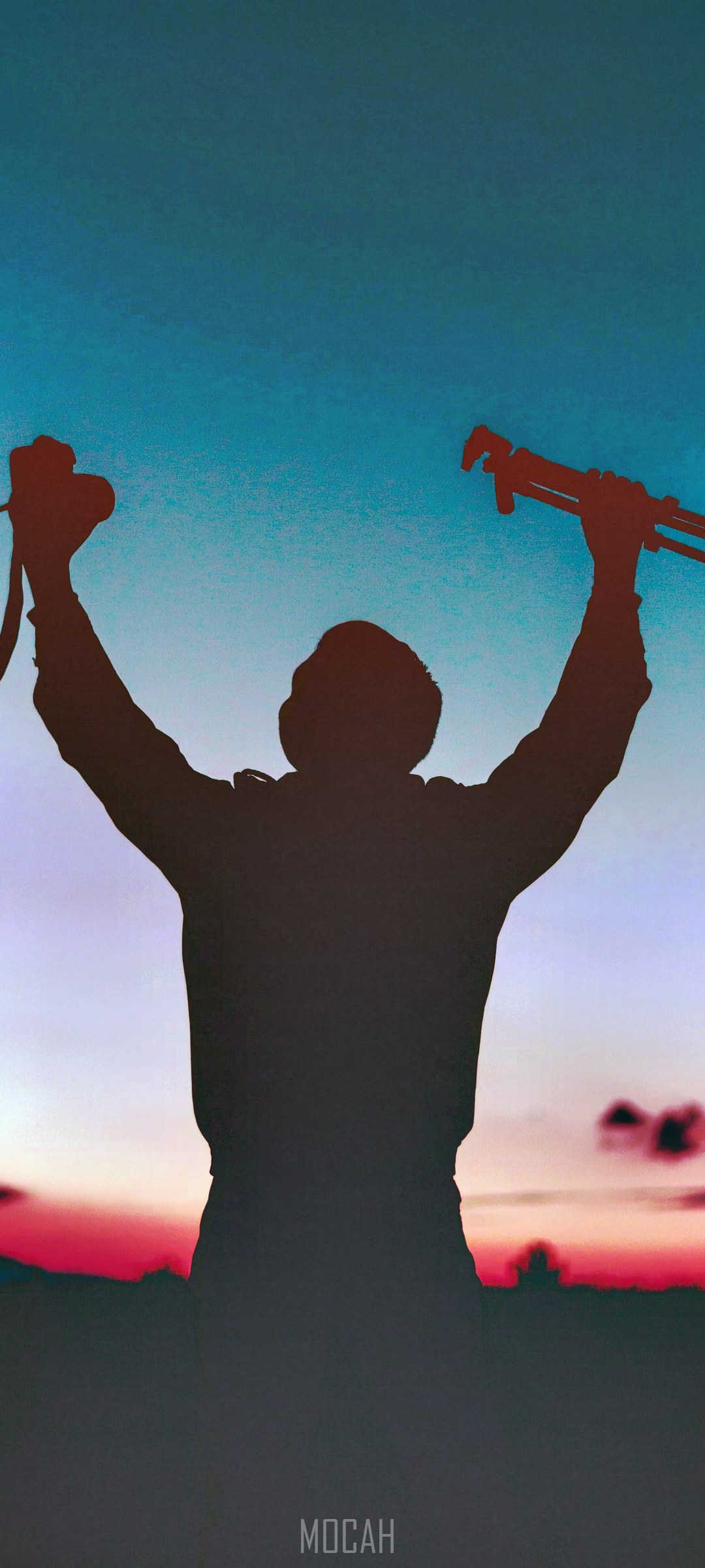 Silhouette of a person with arms raised holding camera and tripod HD Phone Wallpaper