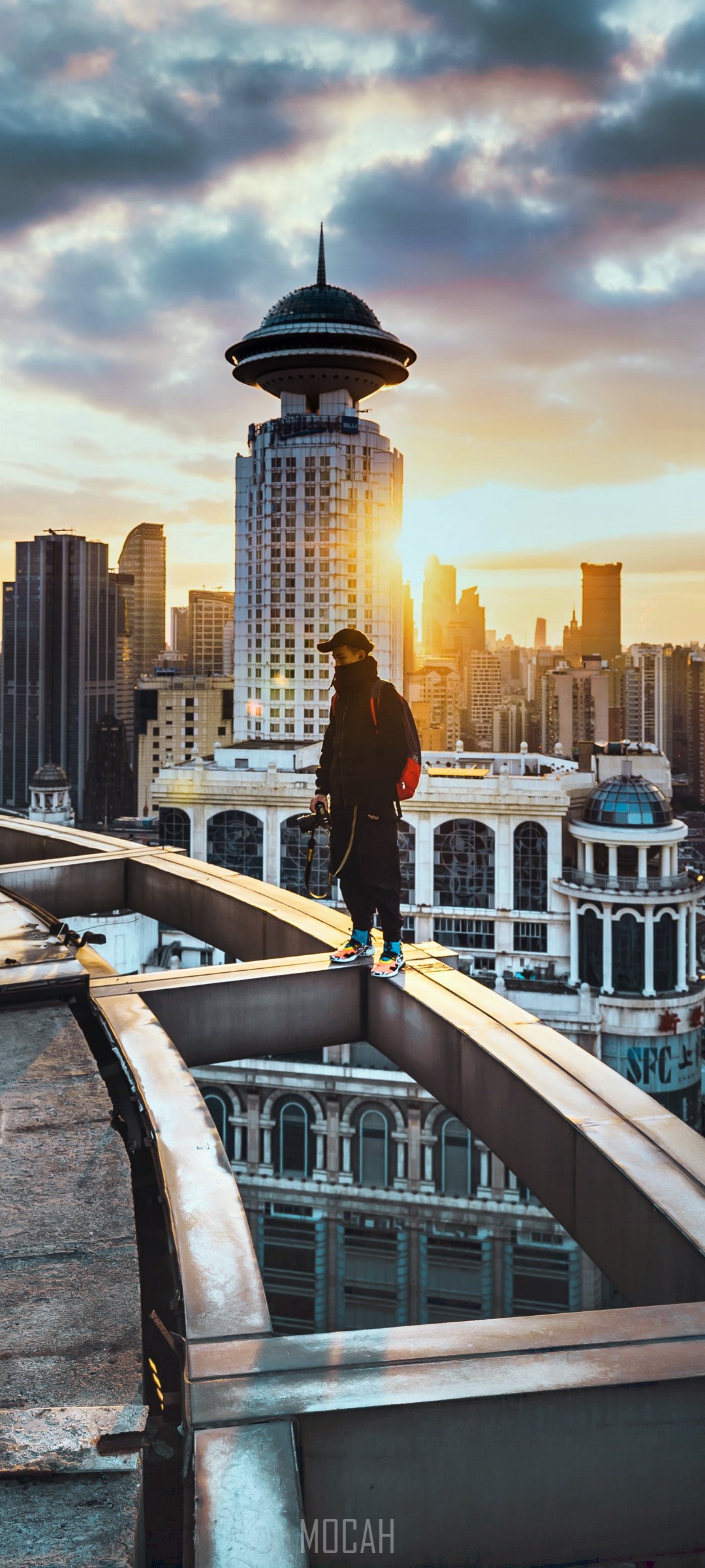 Person on rooftop overlooking Shanghai cityscape at sunset HD Phone Wallpaper