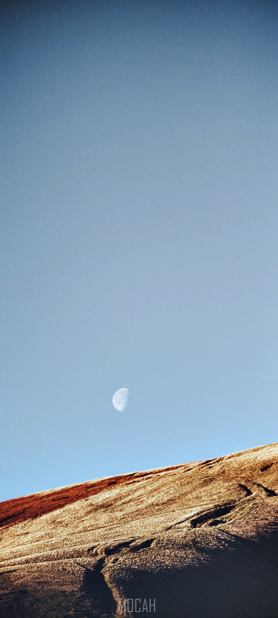 Half moon over a rocky landscape HD Phone Wallpaper