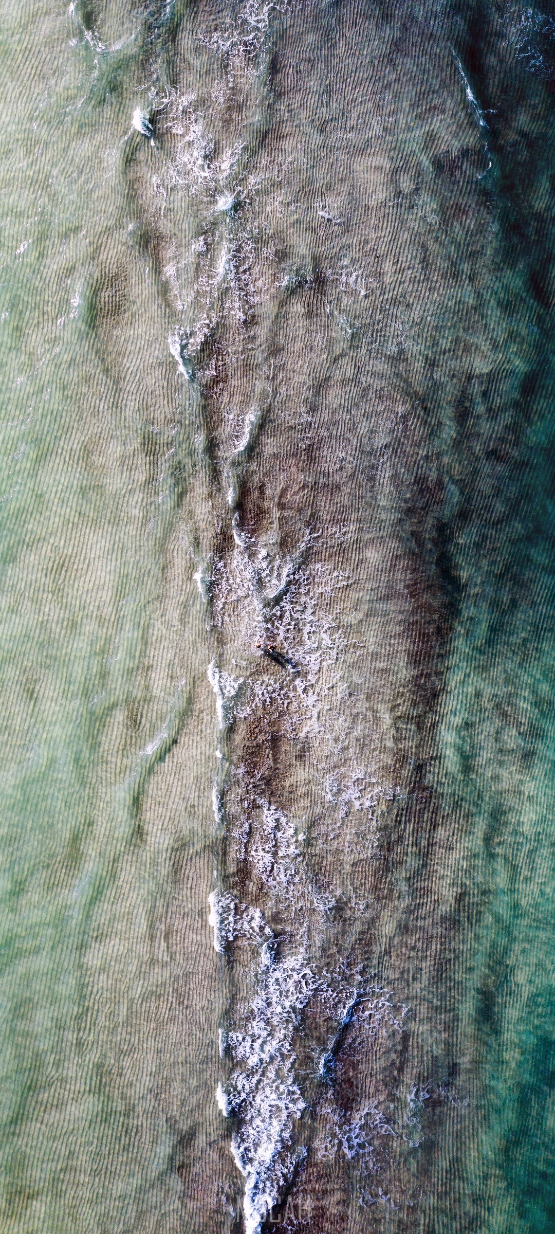 Aerial view of shallow ocean water with waves and sand ripples HD Phone Wallpaper