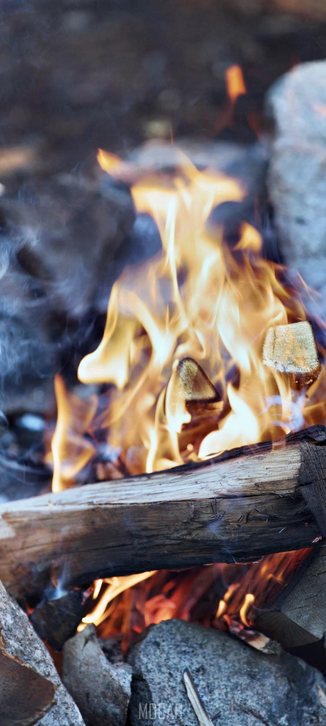 Campfire with burning wood and rocks HD Phone Wallpaper