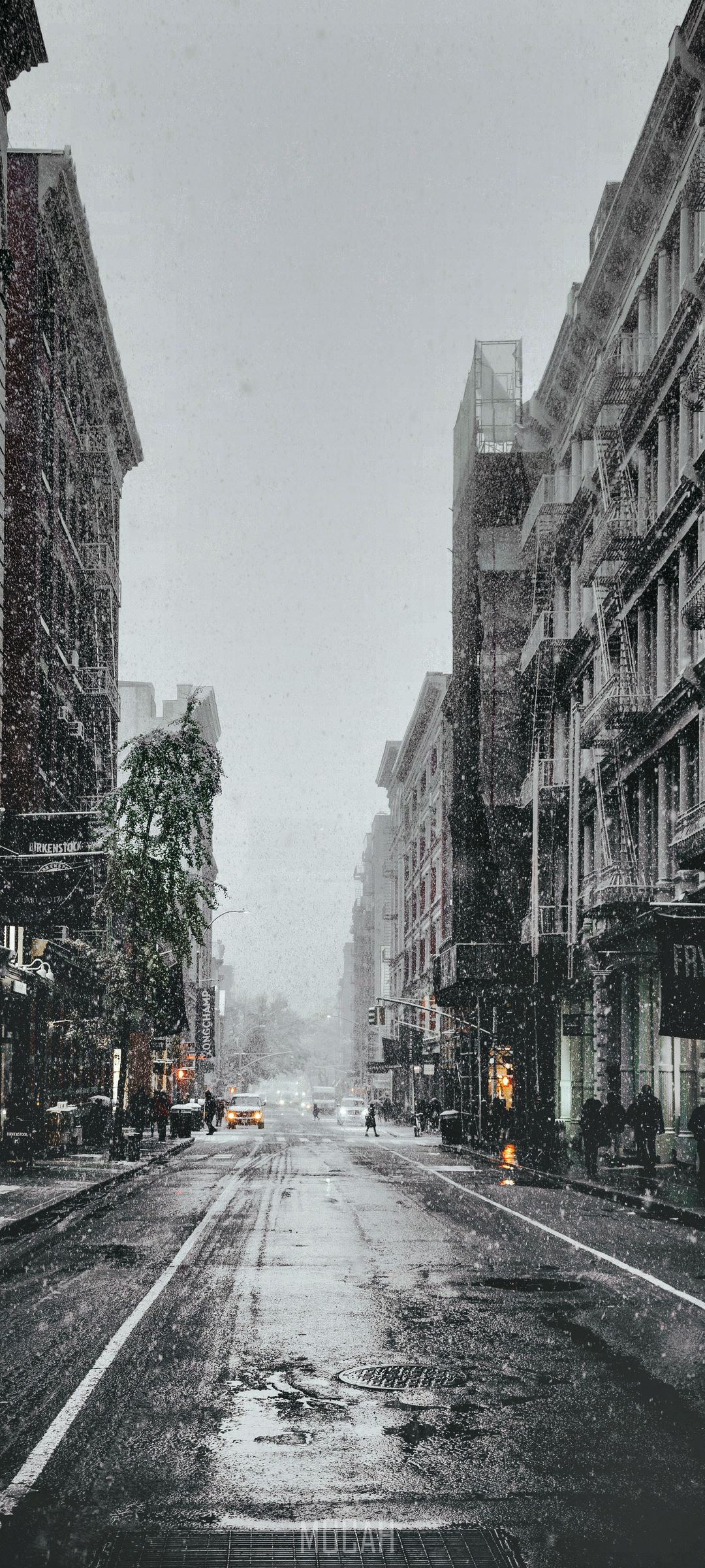 Snowy City Street with Buildings and Cars HD Phone Wallpaper