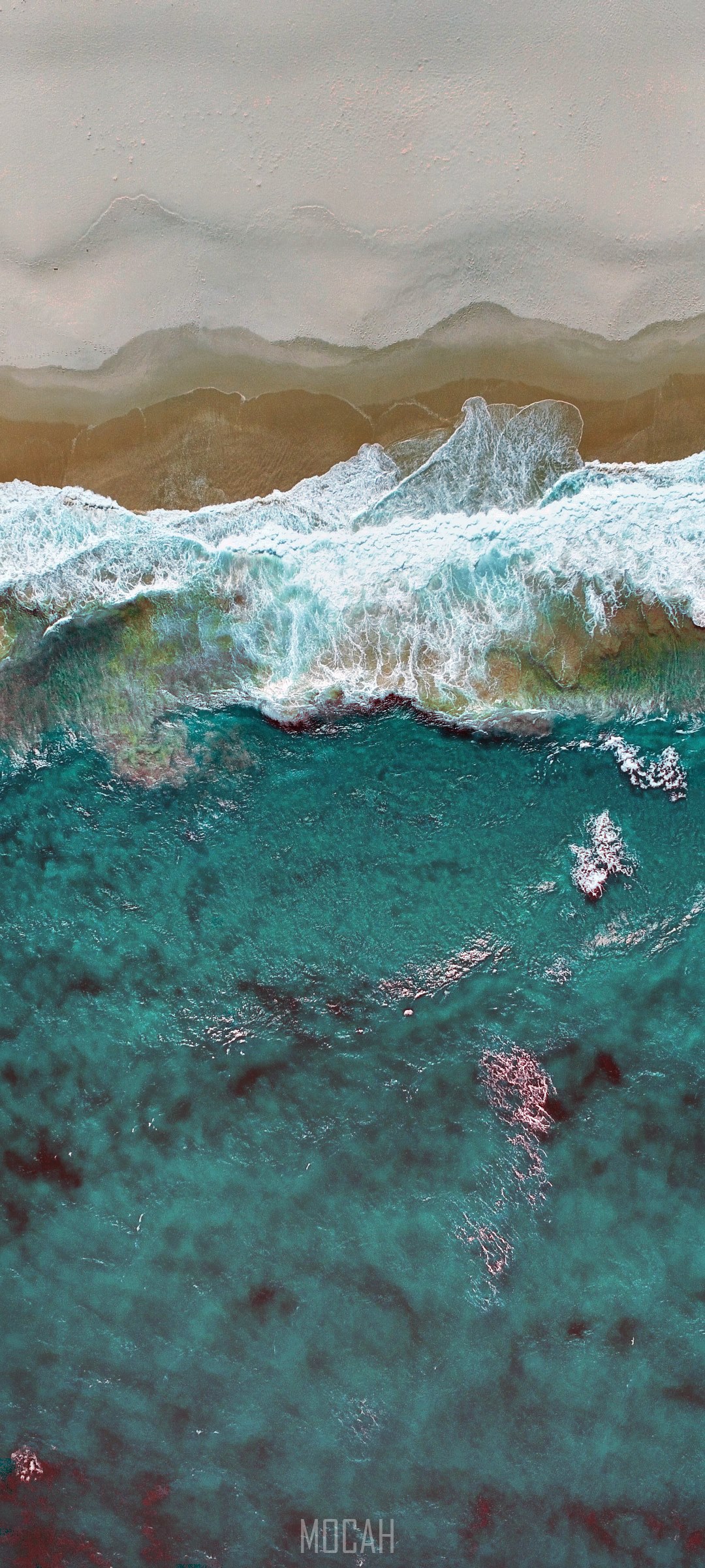 Aerial view of ocean waves crashing on a sandy beach HD Phone Wallpaper