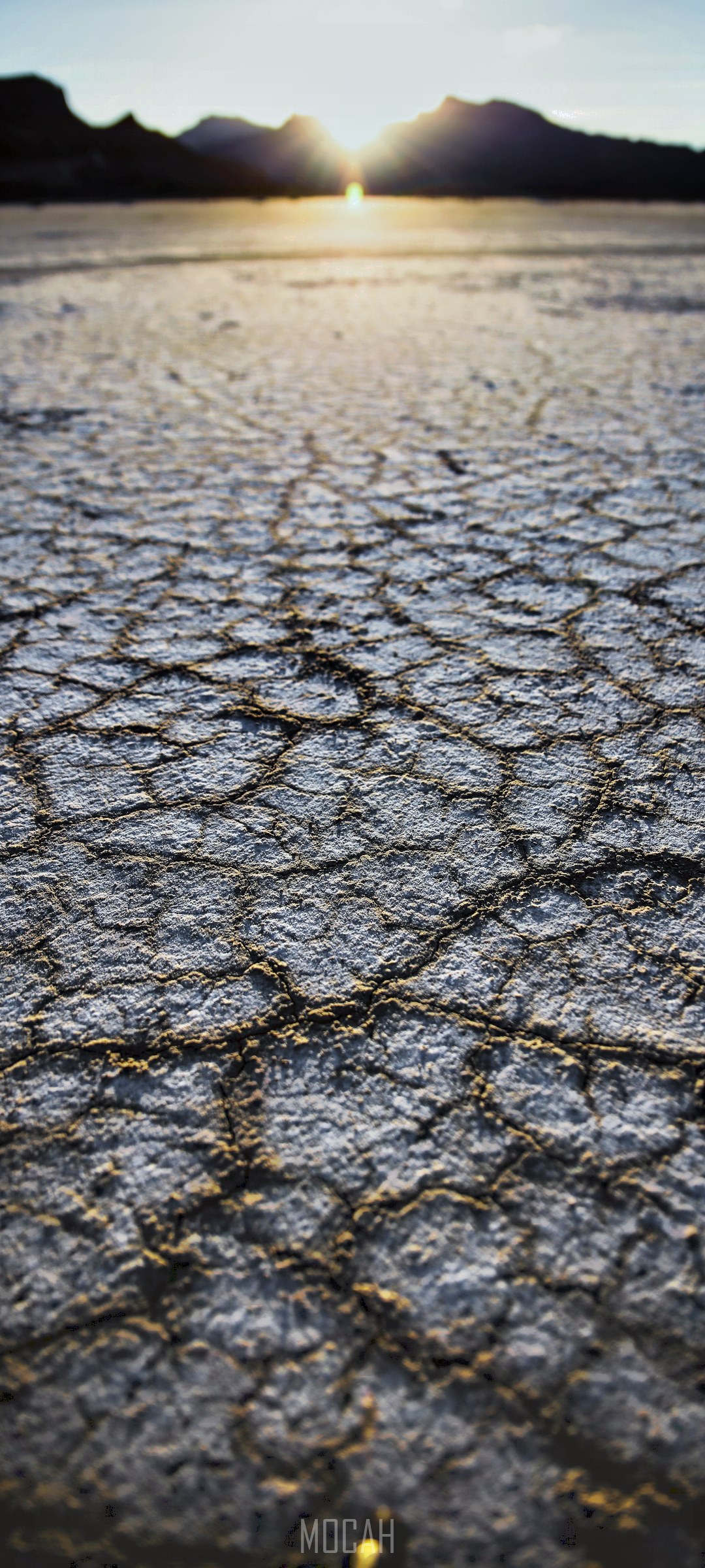 Cracked Earth and Mountains at Sunset HD Phone Wallpaper