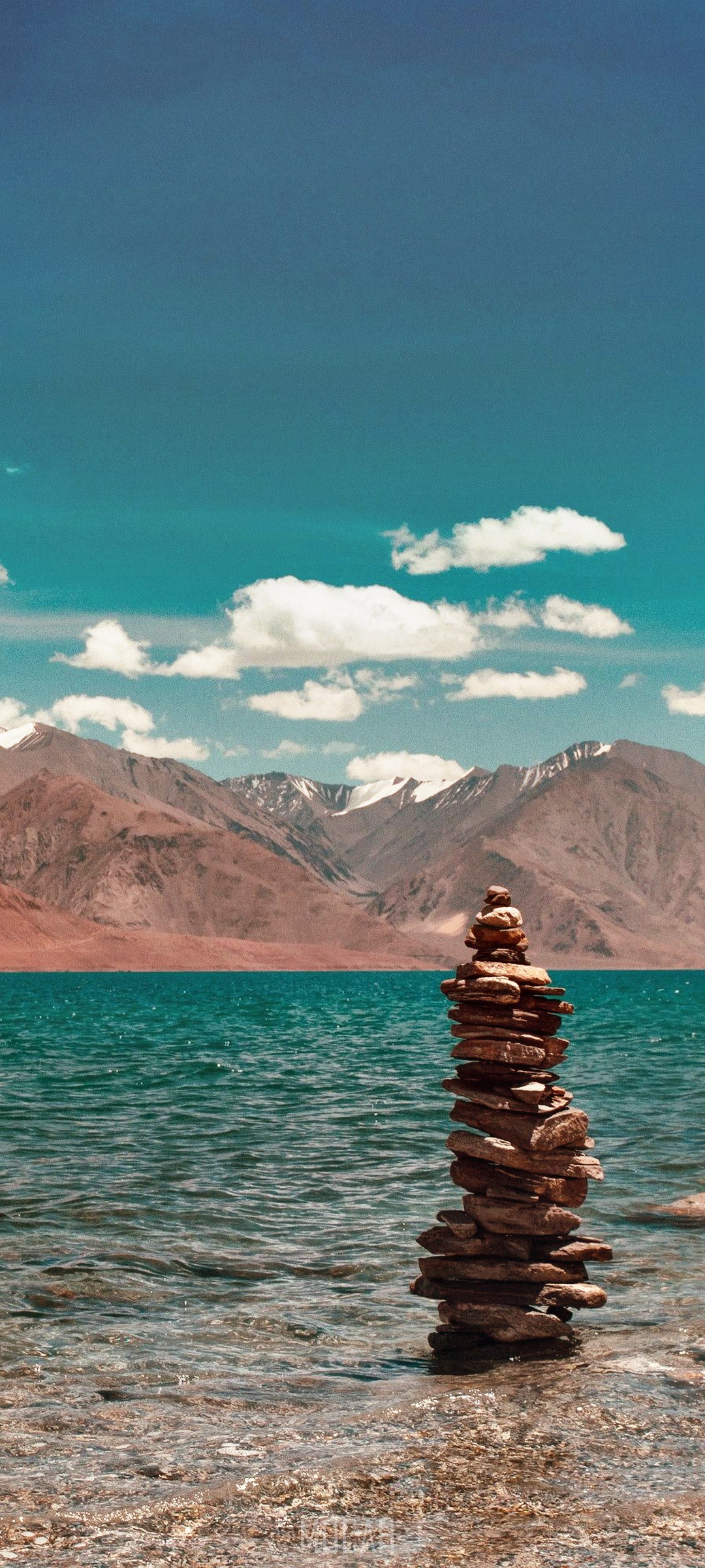 Stone cairn in Pangong Tso lake with mountains HD Phone Wallpaper