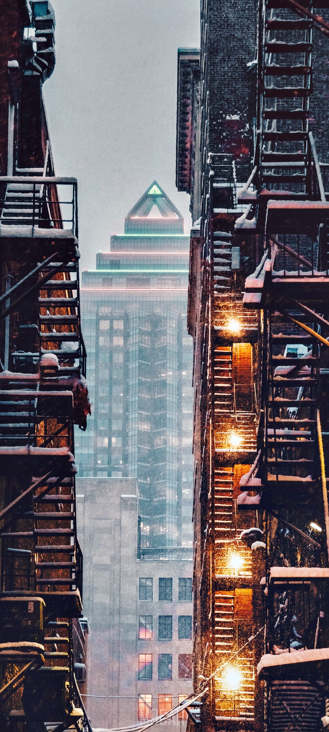 Alleyway with fire escapes and skyscraper in winter HD Phone Wallpaper