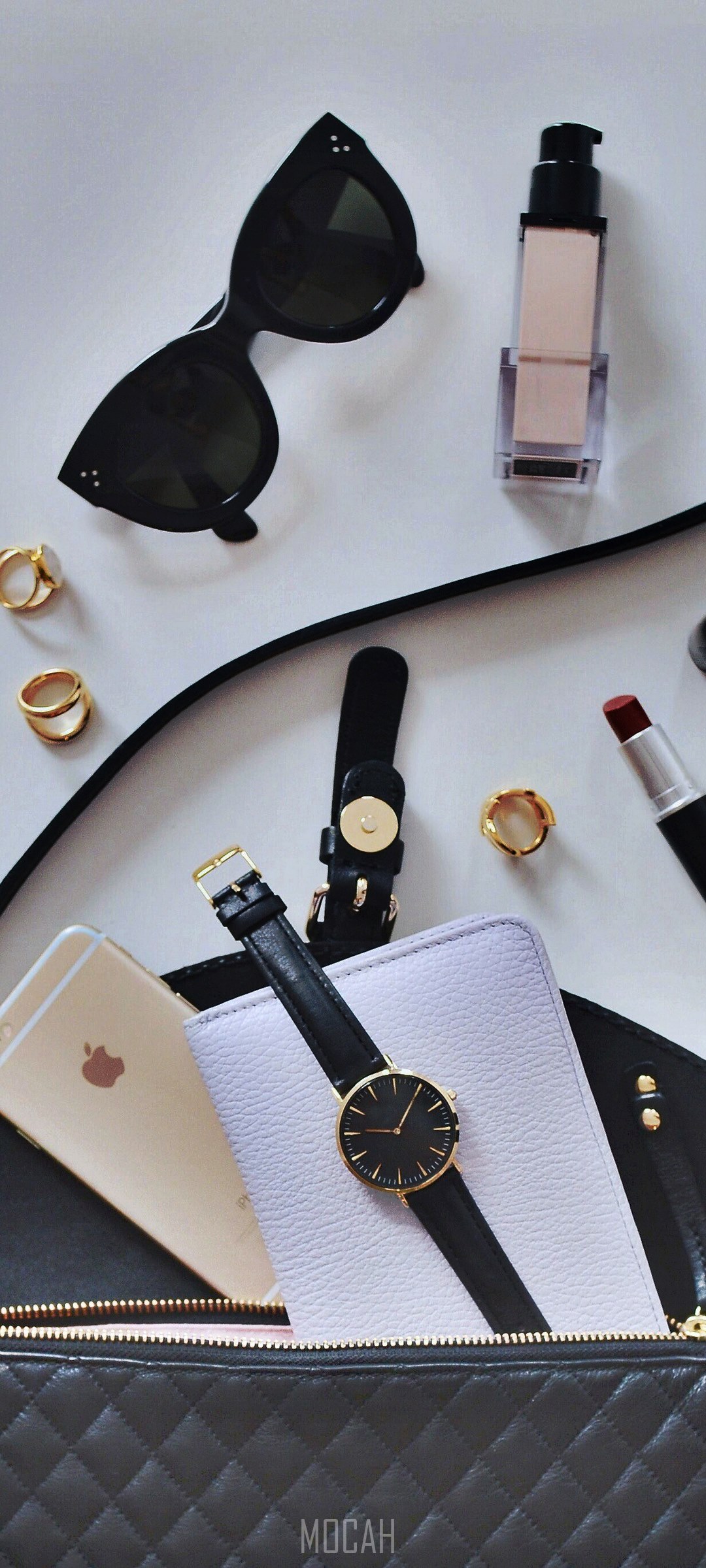 Contents of a woman's purse on a white surface HD Phone Wallpaper