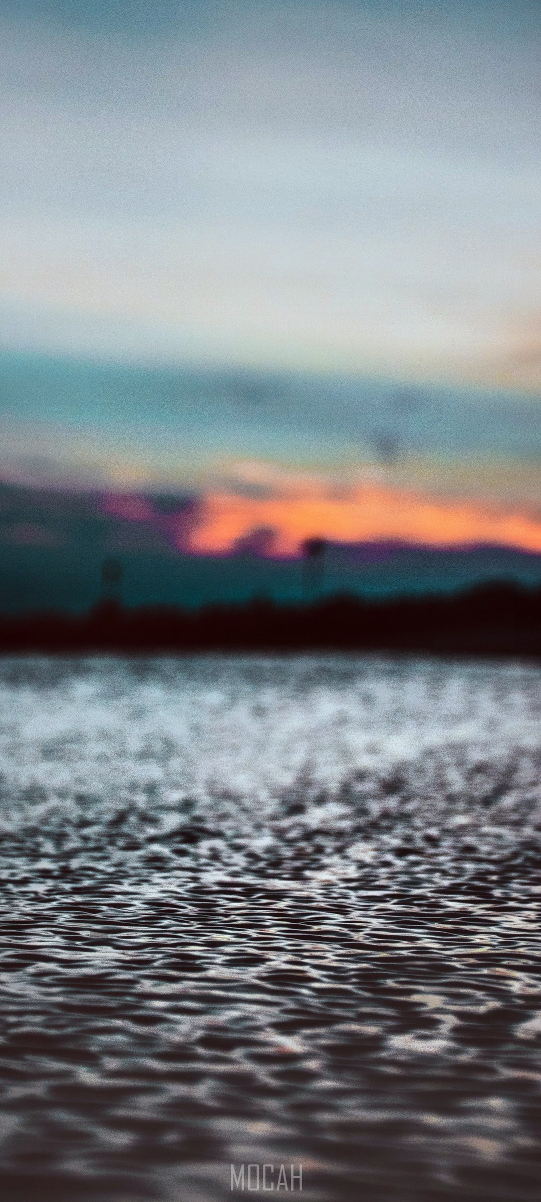 Blurred ocean sunset with ripples HD Phone Wallpaper