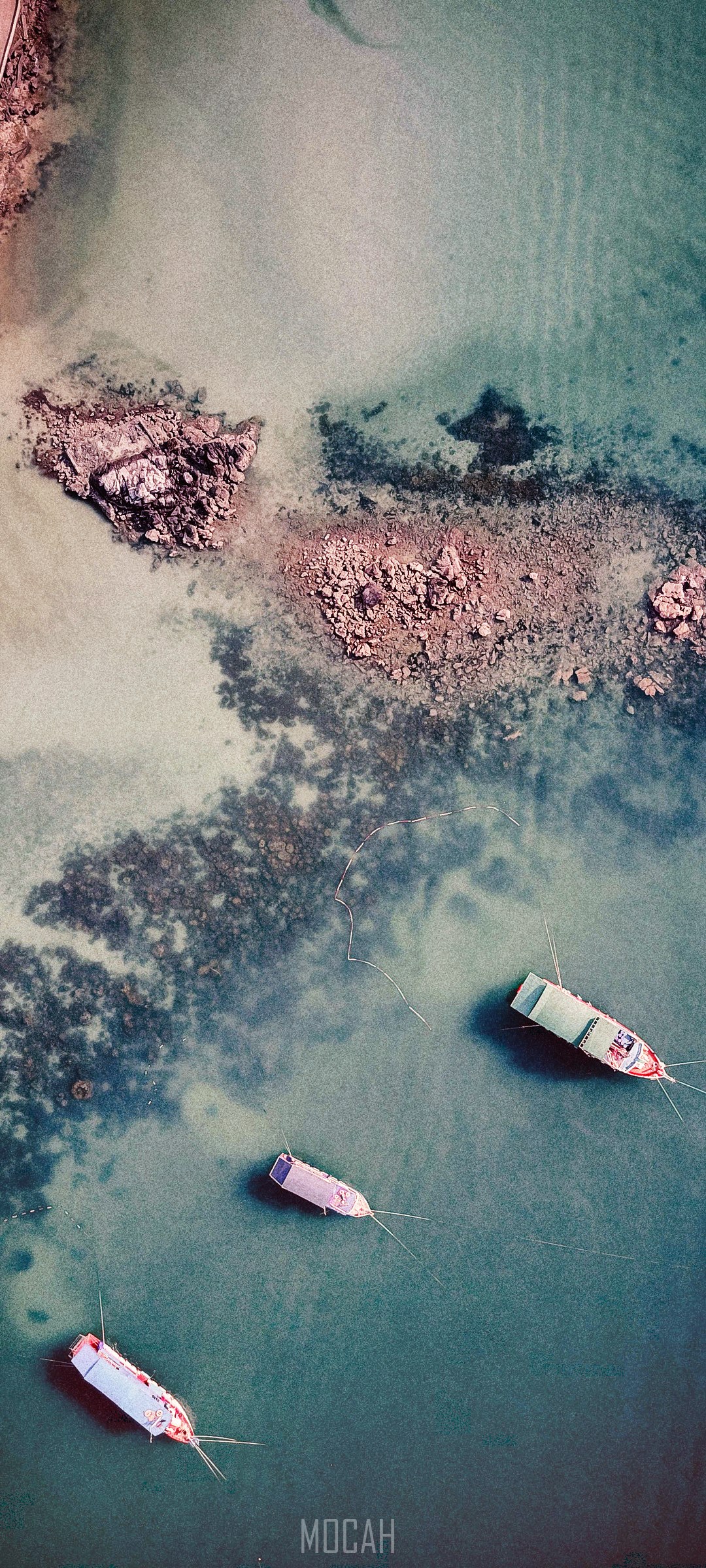 Aerial view of boats near rocky shore HD Phone Wallpaper